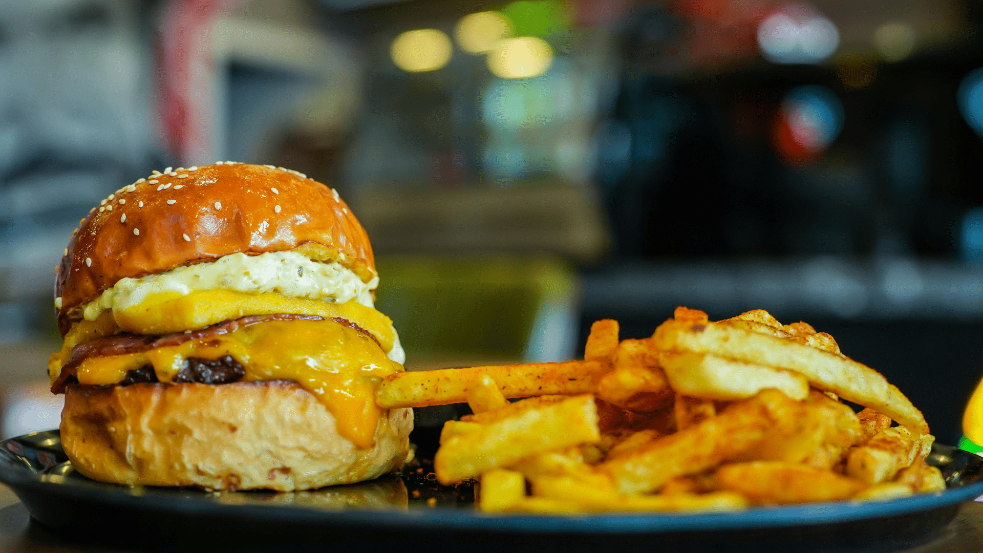 Burger and fries served in a restaurant with a blurred background