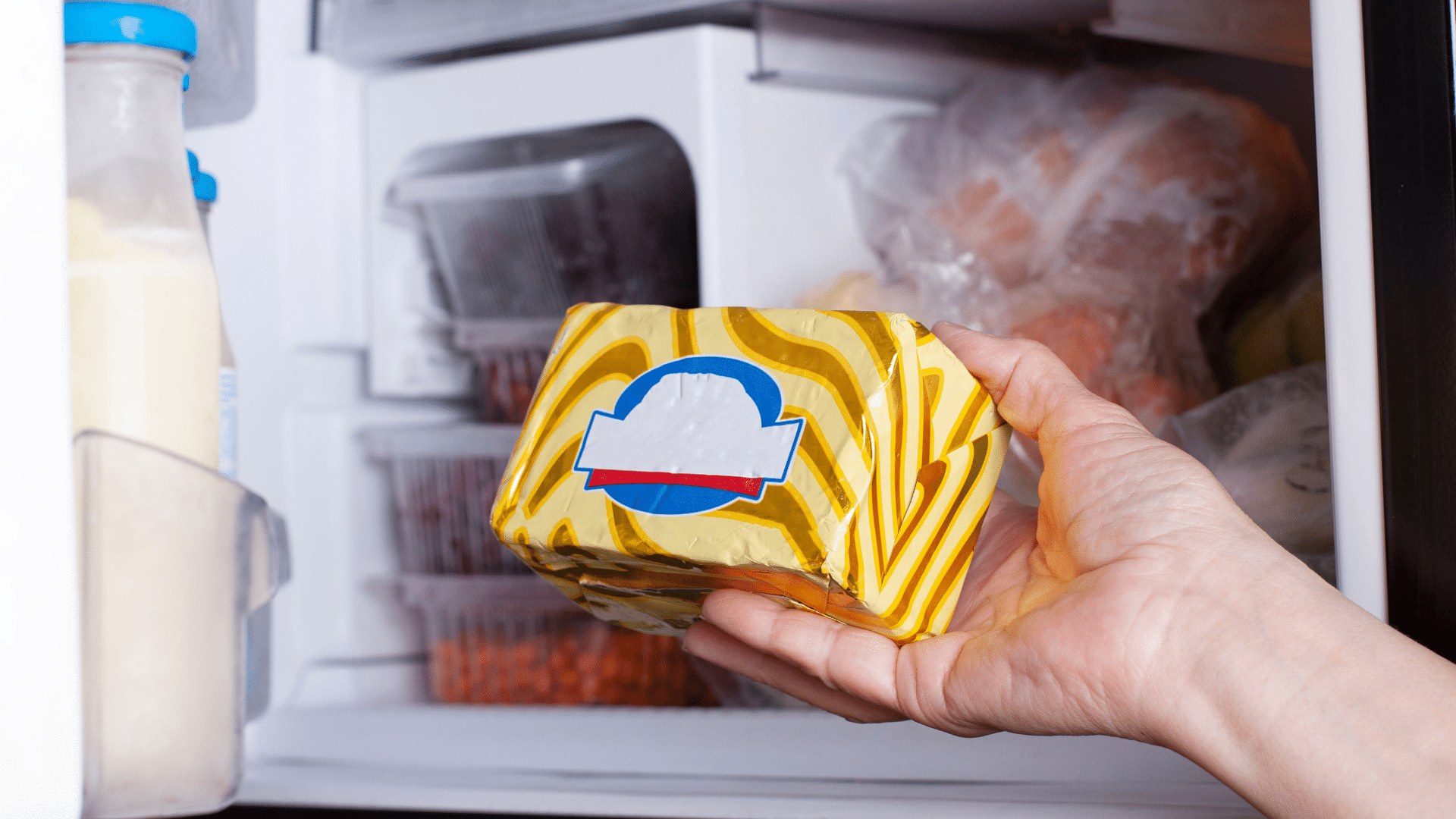 Frozen butter stored in refrigerator with various vegetables