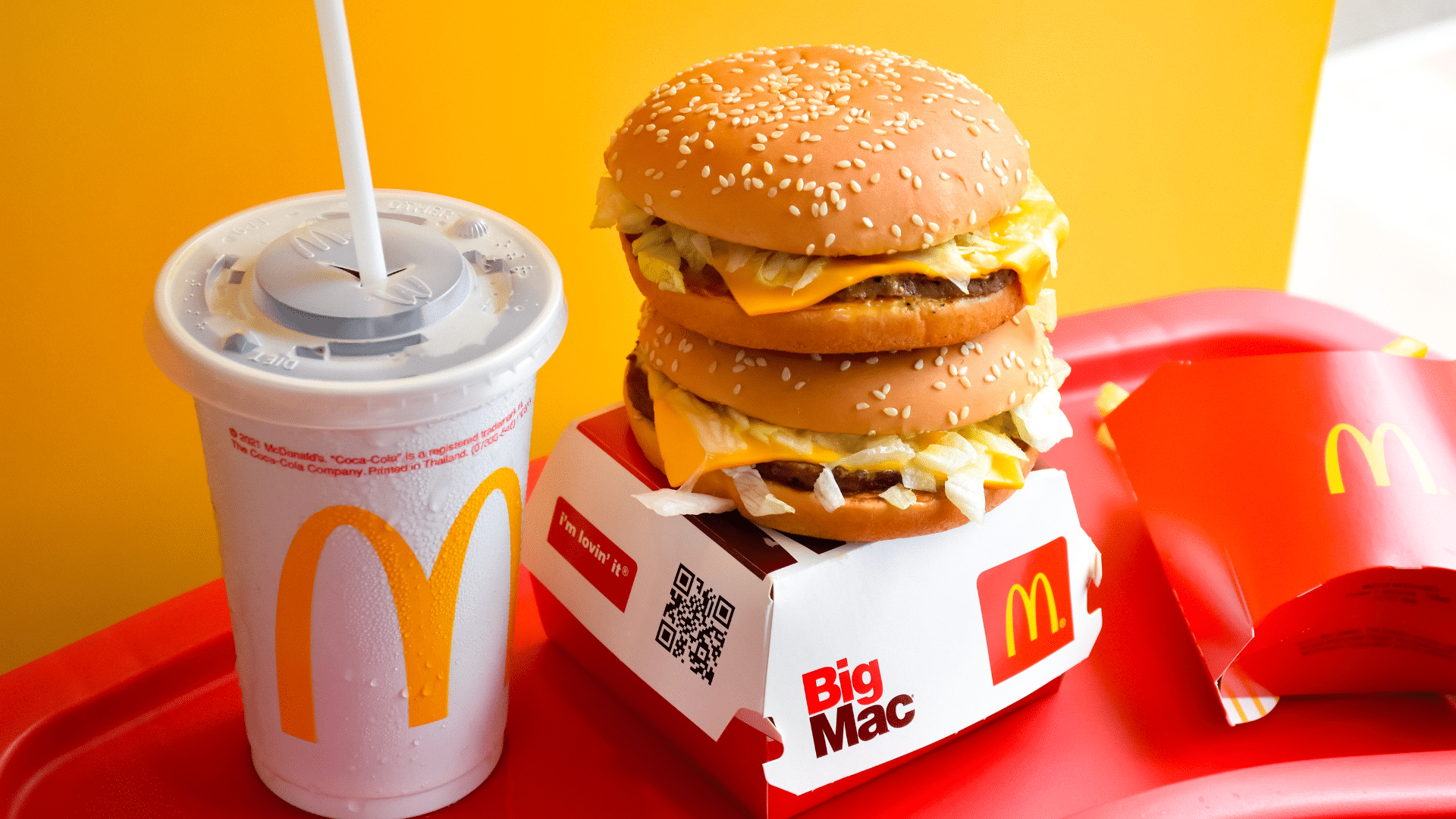 McDonald’s meal on a tray with fries, burger, and drink inside a restaurant