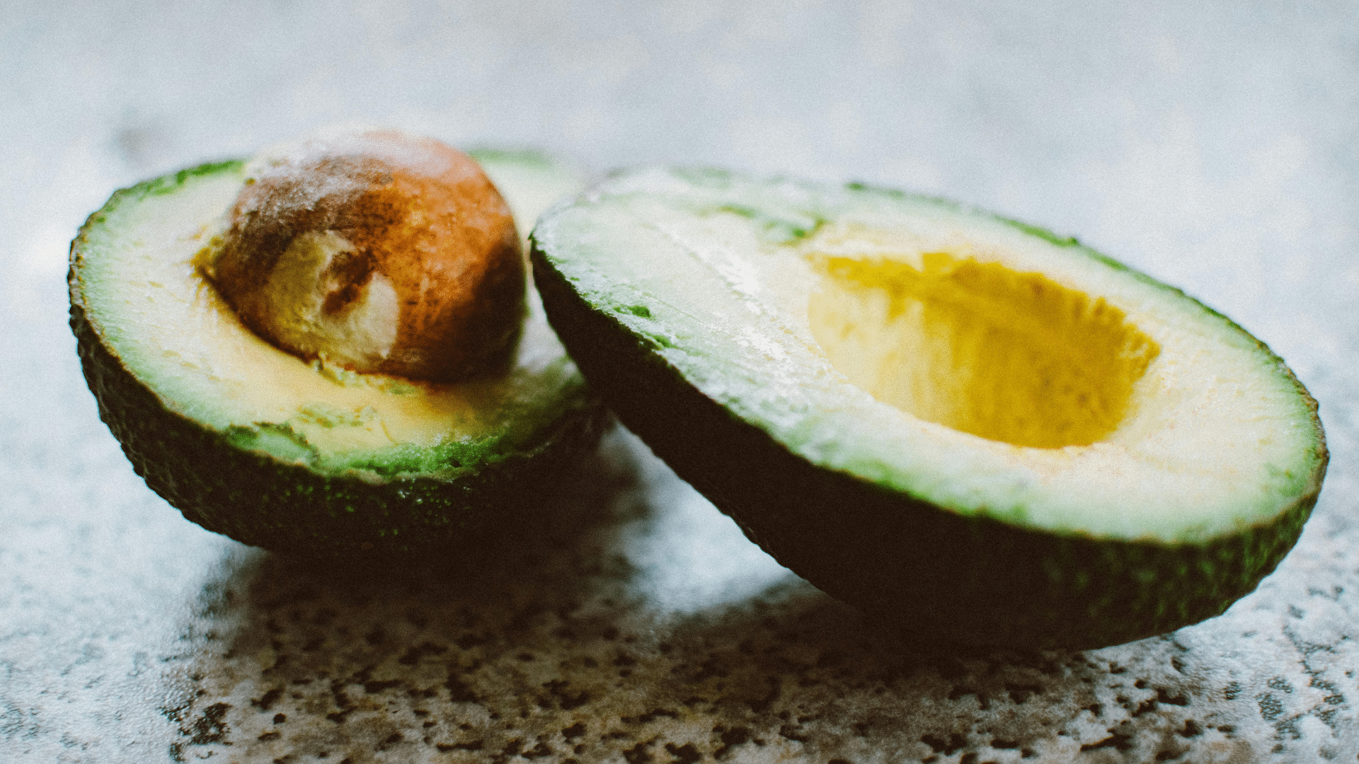 Close-up of sliced ripe avocado on a cutting board