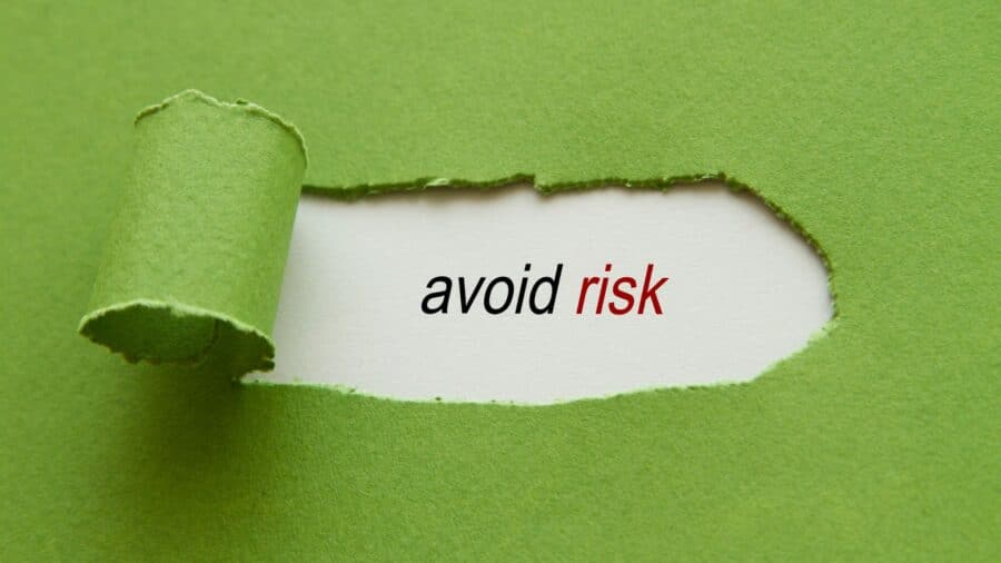 Avoid risk written under torn paper