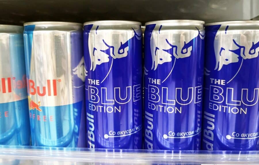 Variety of energy drink cans in a refrigerator display.