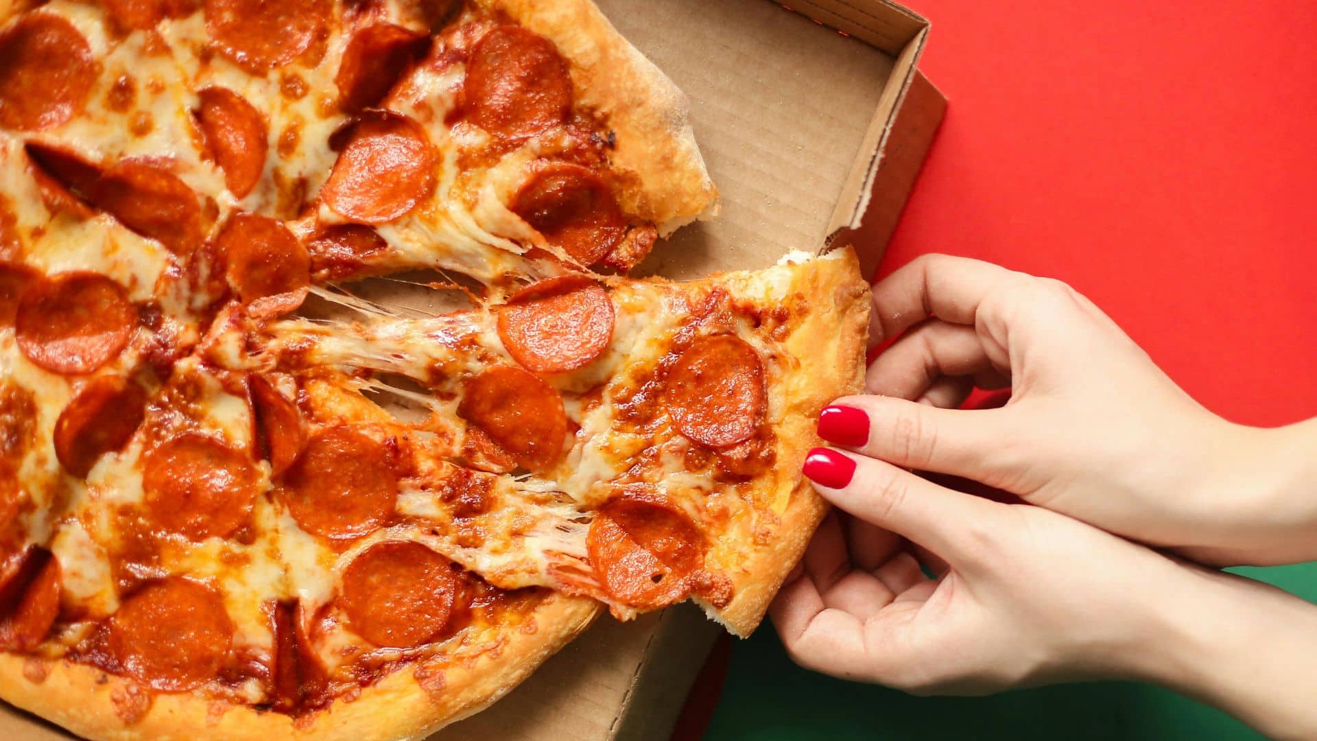 Pizza on a person's hand