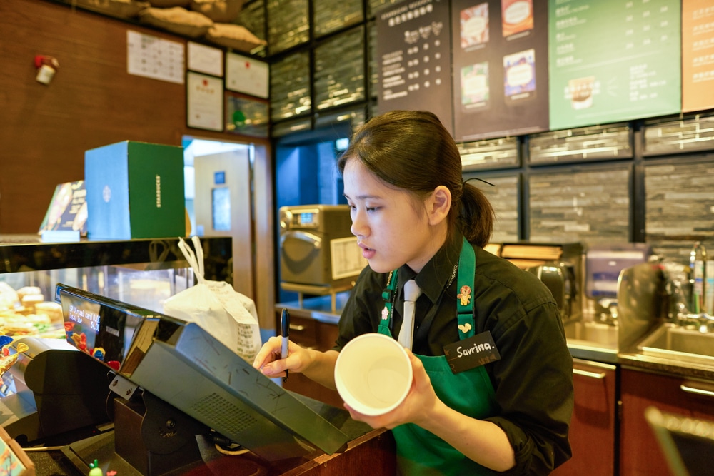 Starbucks barista filling an order
