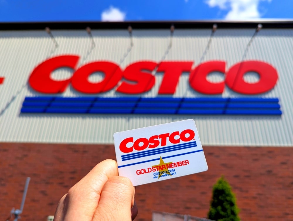Raleigh, North Carolina - May 2 2025: Costco Wholesale Gold Star Membership Card Held In Hand in Front of Storefront Location