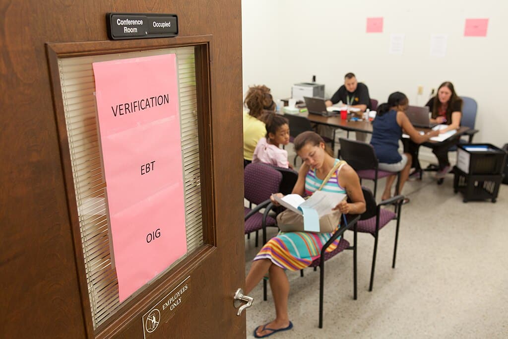 Telena Alexander (lt.) waits for her name to be called during the final stage of a three-step process for the U.S. Department of Agriculture (USDA) Food and Nutrition Service (FNS) Disaster Supplemental Nutrition Assistance Program (DSNAP) assistance in the form of an Electronic Benefits Transfer (EBT) card at the West Virginia Department of Health and Human Resources building located in Lewisburg WV, on July 27, 2016. USDA Photo by Steve Ausmus.