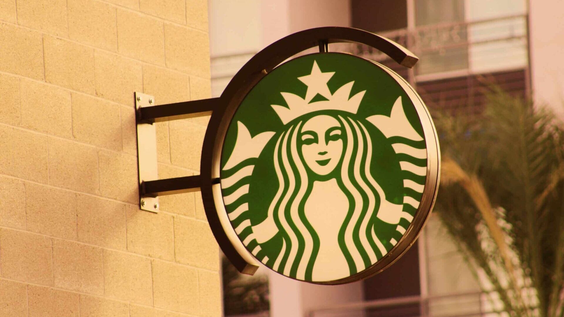 Outdoor Starbucks store sign against a building façade