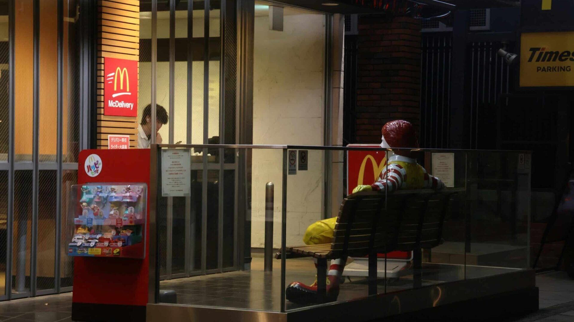 Person standing outside a closed McDonald’s restaurant