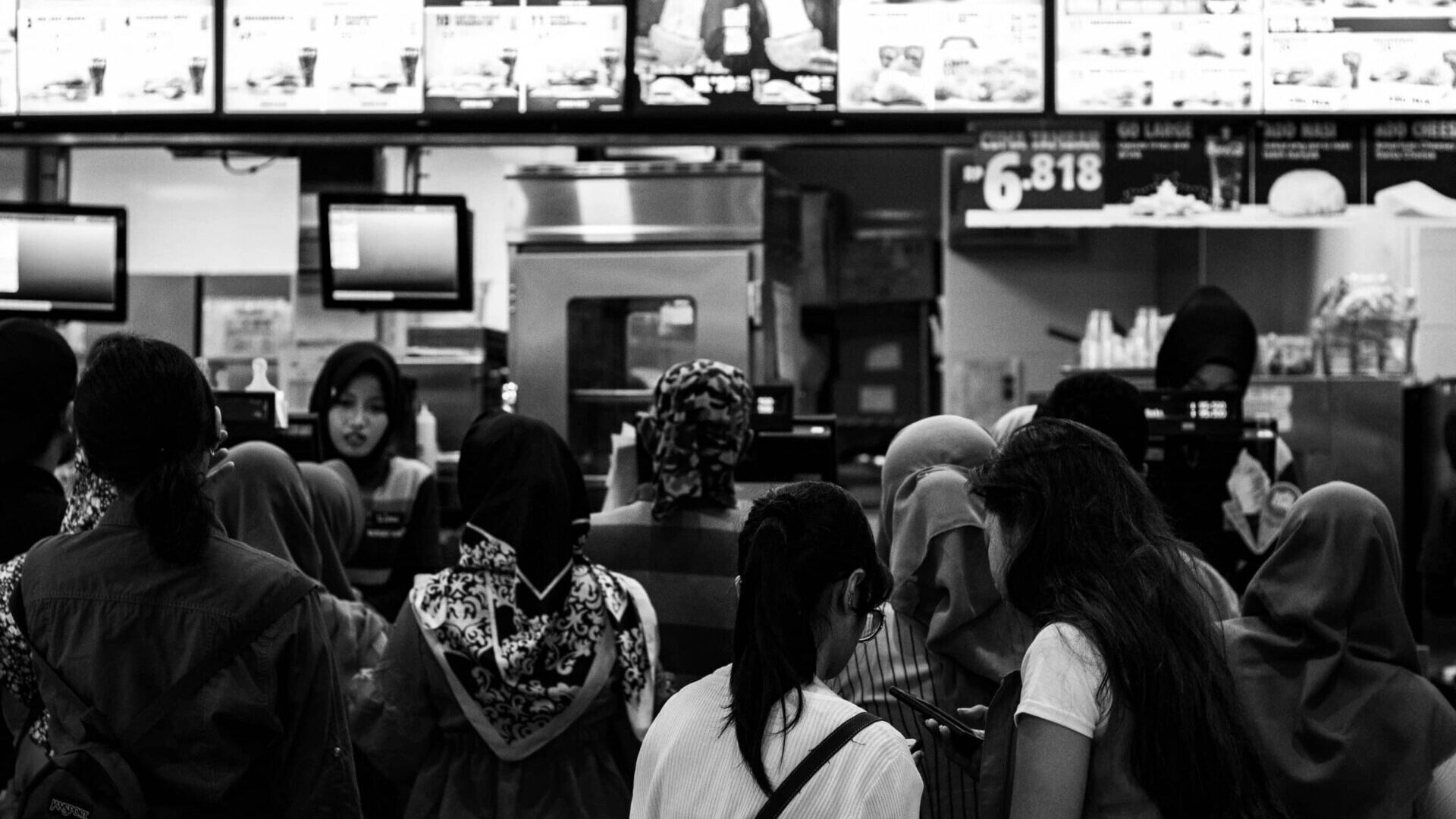 Group of customers gathered inside a fast-food restaurant
