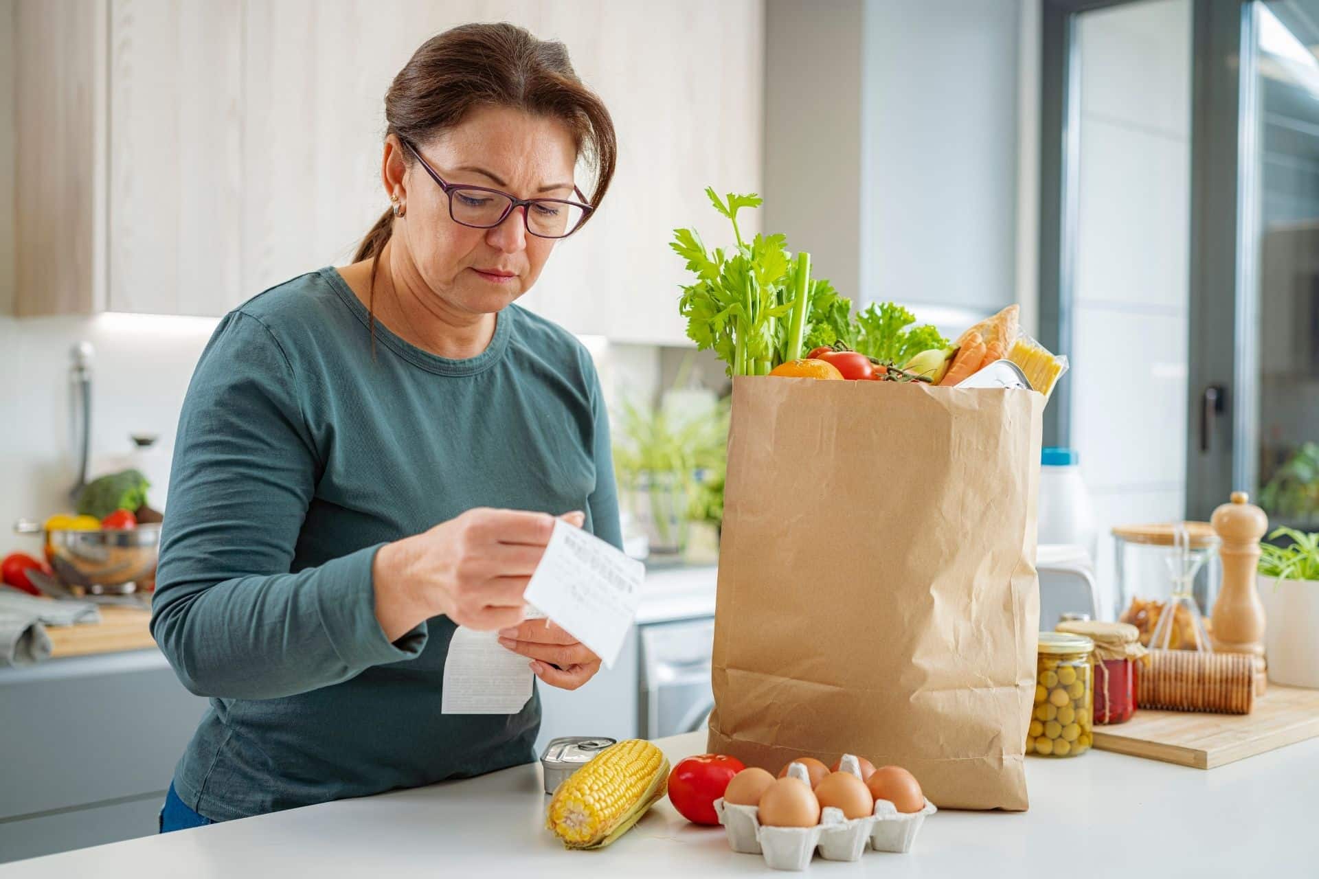 Woman checking receipt after buying groceries