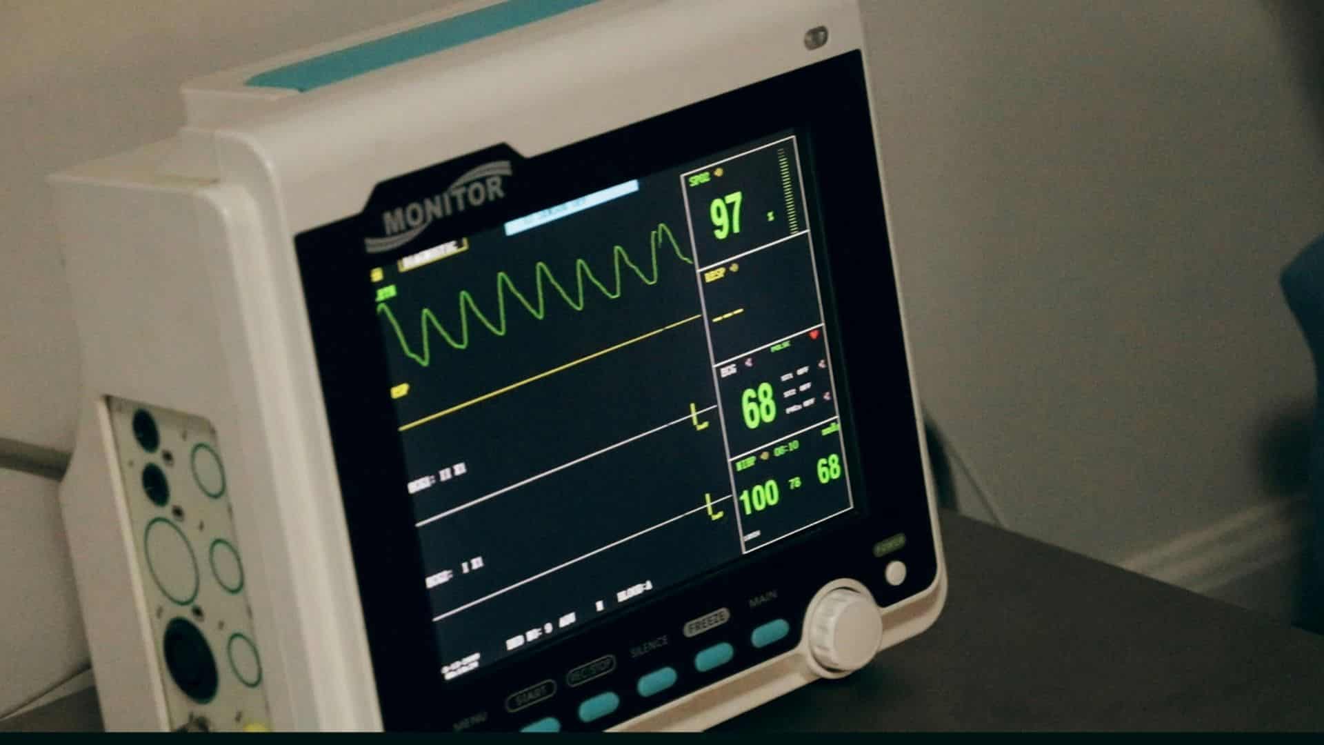 Digital heart rate monitor displaying vital signs on a medical screen