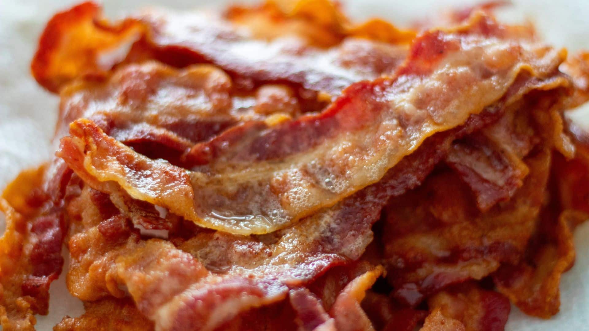 Cooked crispy bacon strips arranged and ready to eat