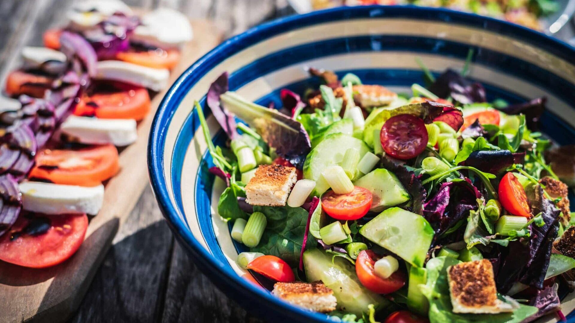 Leafy vegetable dish served in a blue ceramic bowl.