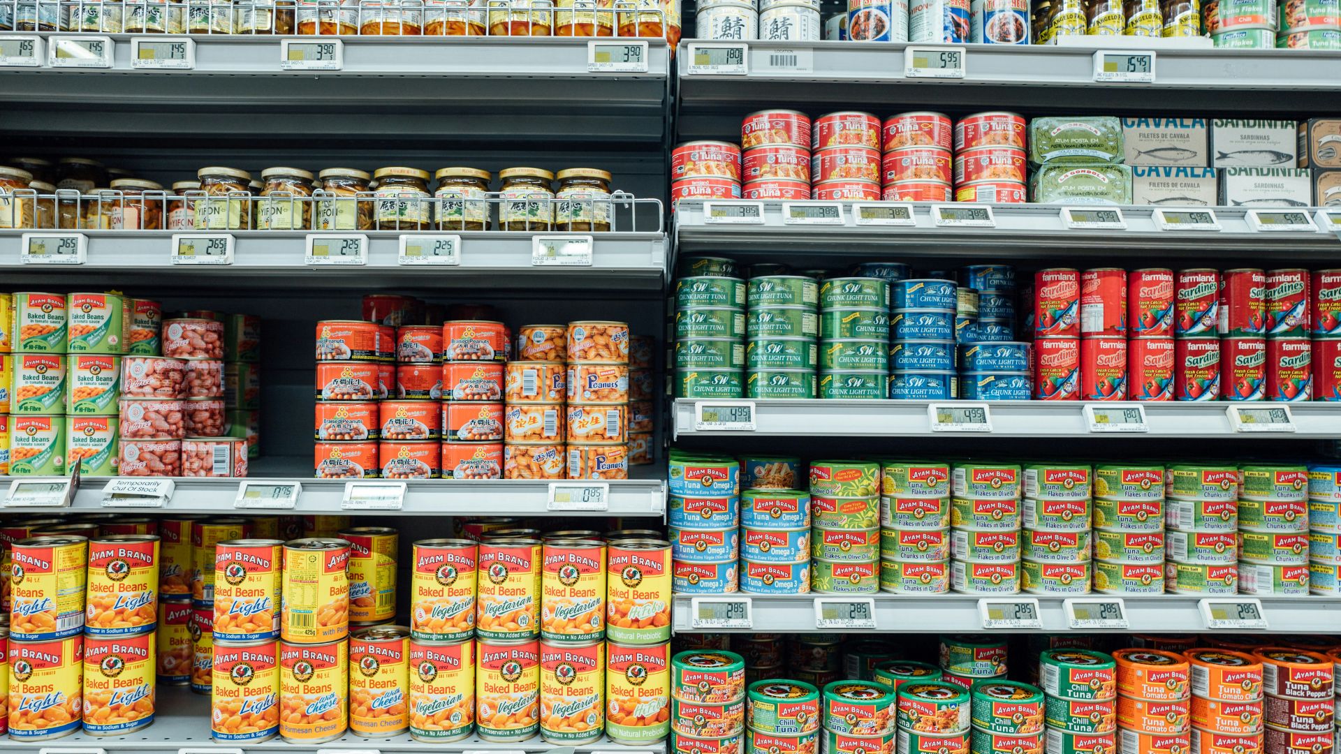 Plastic food containers with red and white labels on a table