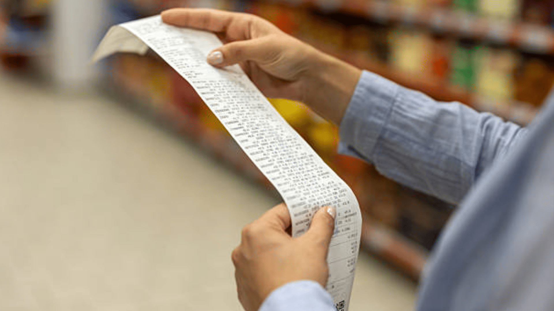 Person holding grocery receipt