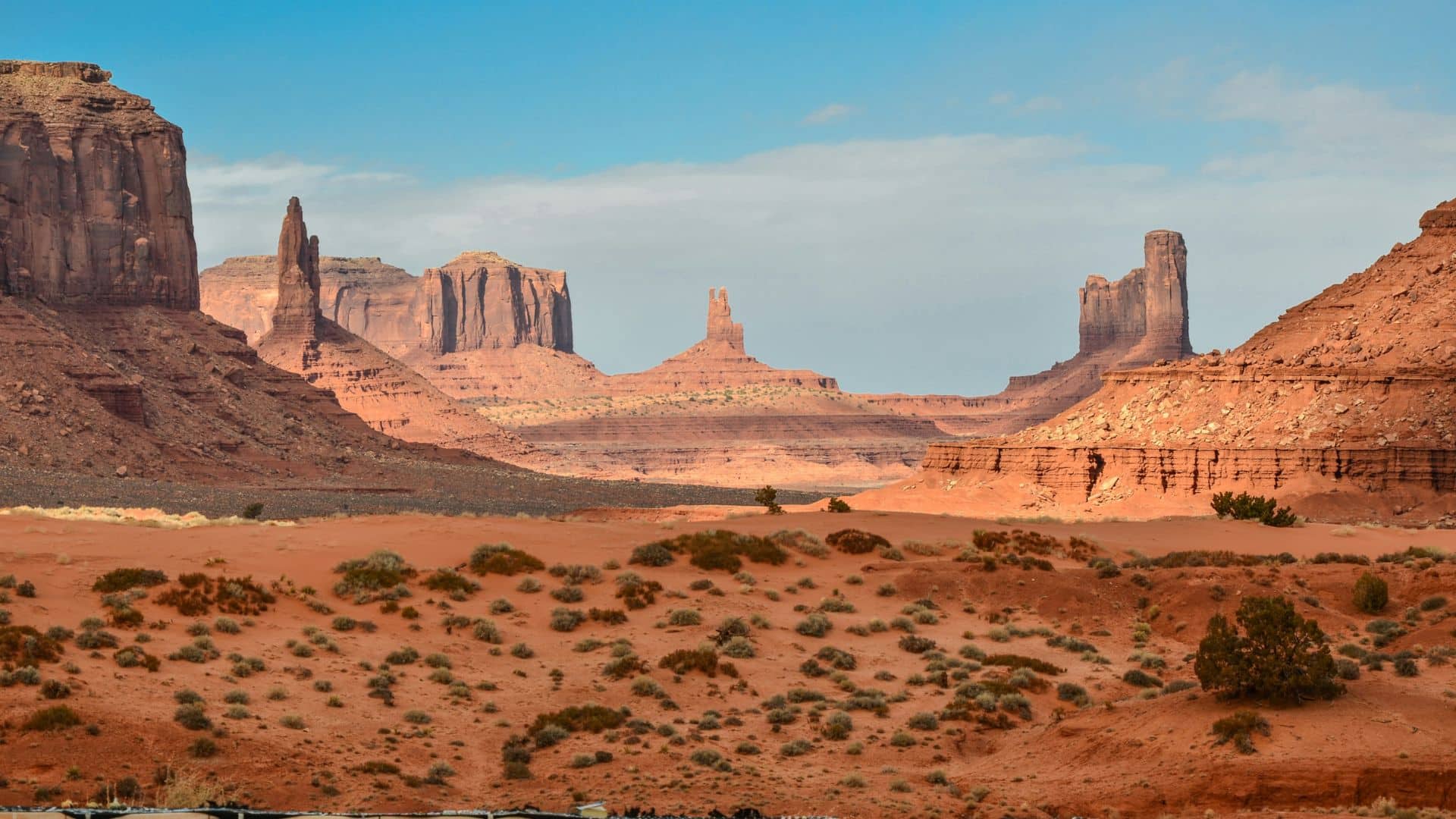 Rock formations rising from dry ground under open sky