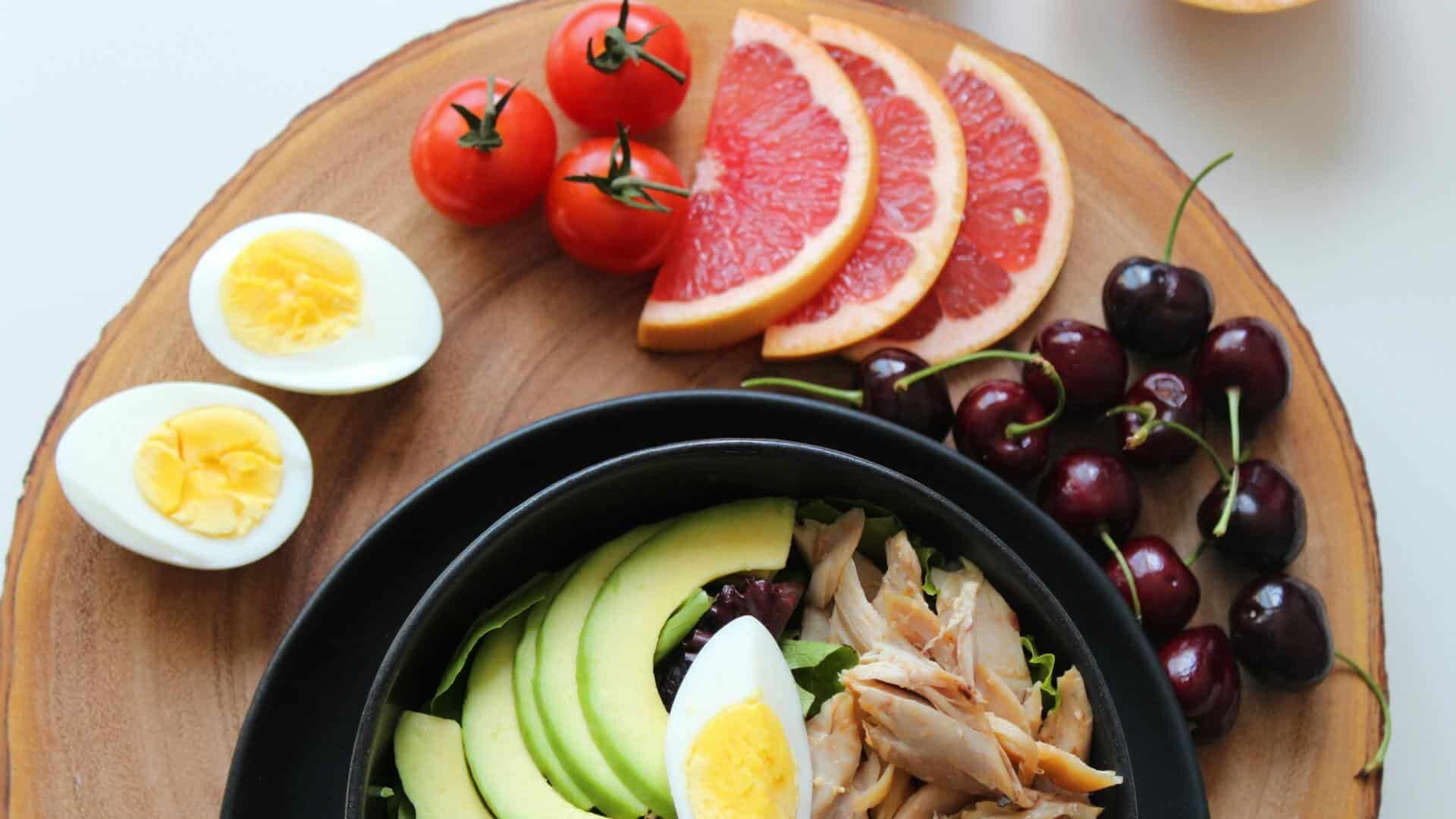Variety of foods displayed on a wooden coaster.