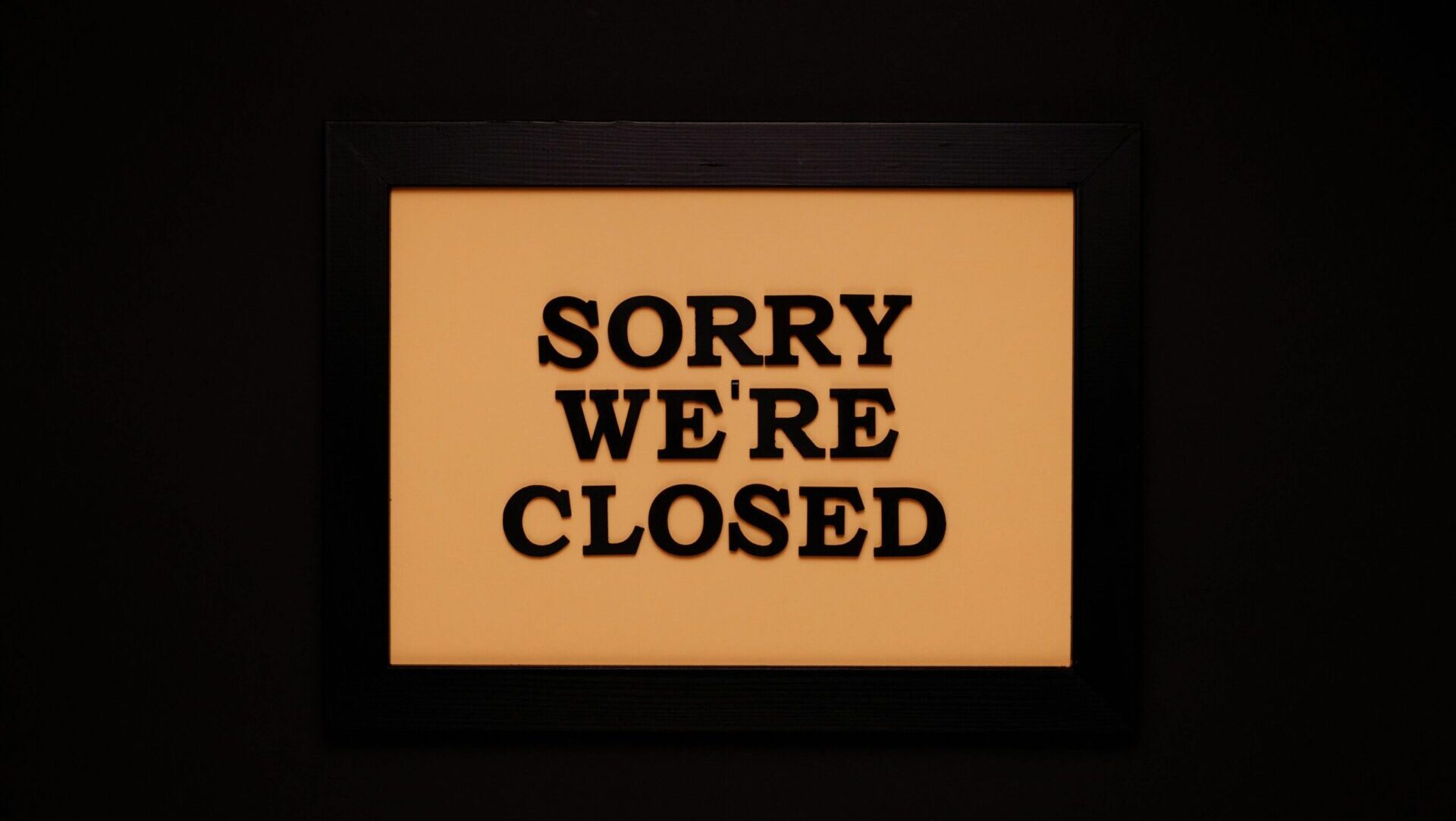 Black wooden frame with white text on a black background.