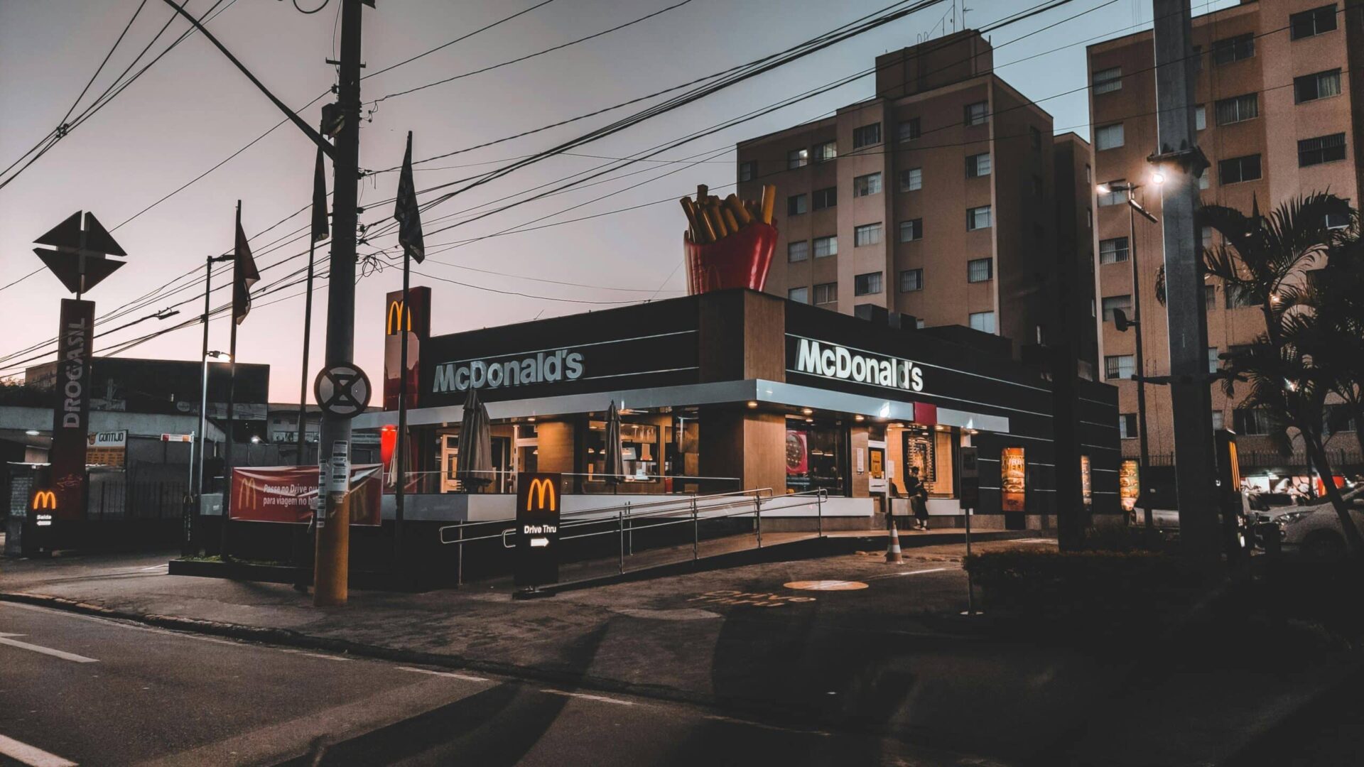 Empty suburban street with a small fast-food restaurant on the corner.