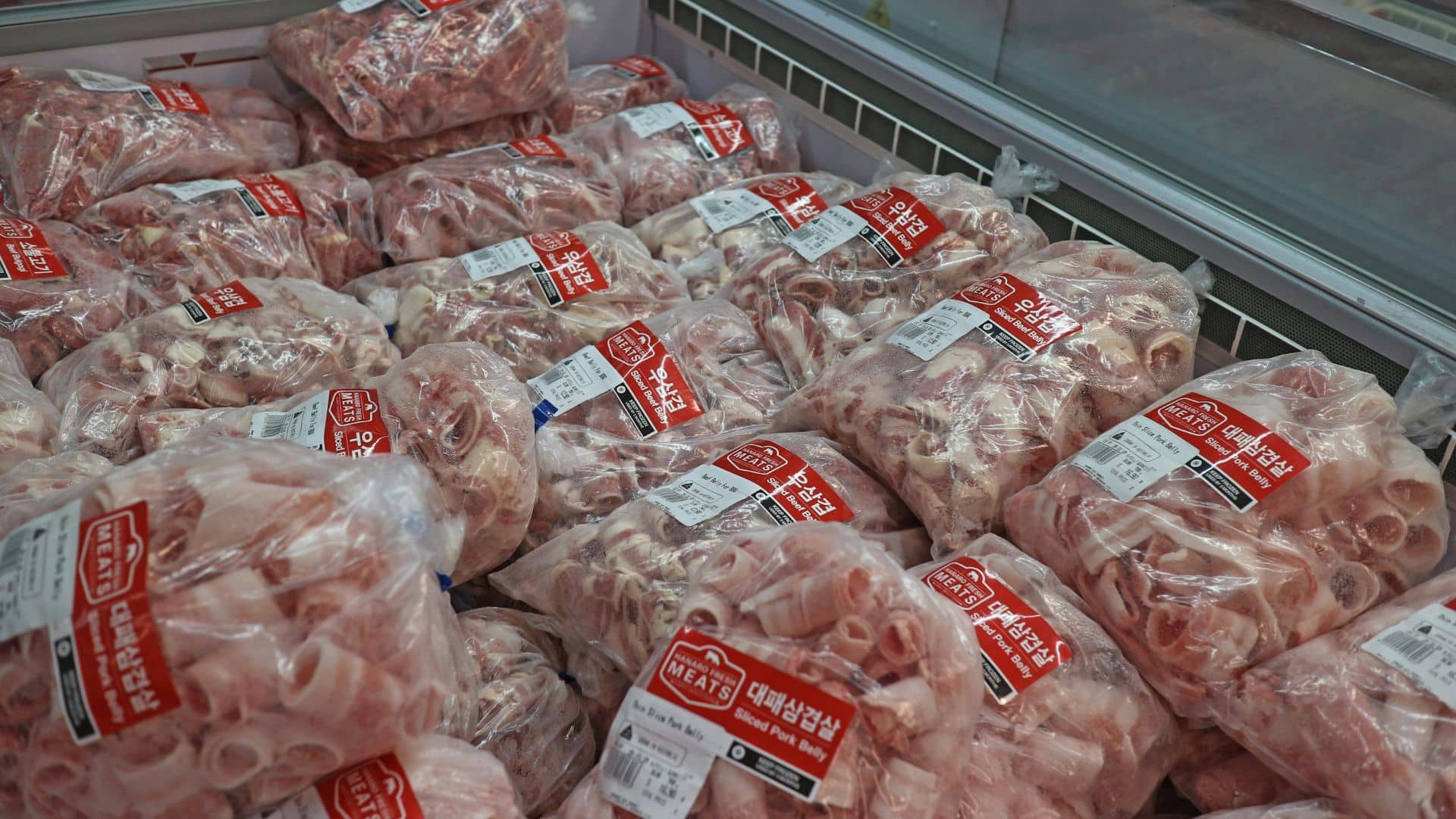 Packaged raw meats wrapped in plastic inside a grocery display