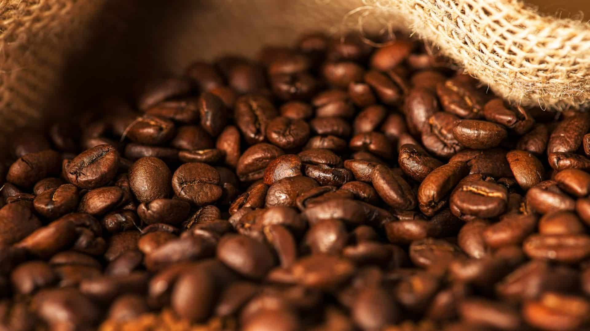 Close up photo of roasted coffee beans in a burlap sack