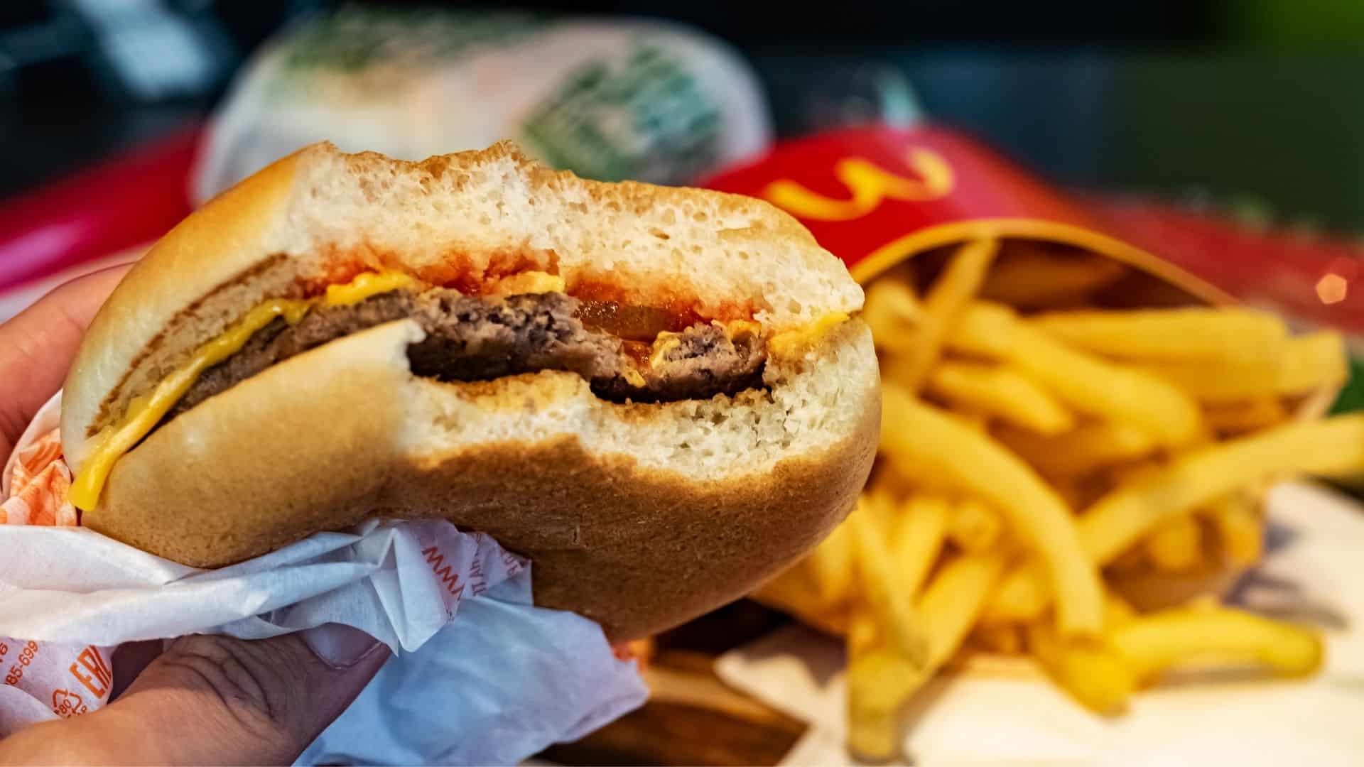 Close-up of a bitten cheeseburger at McDonald's