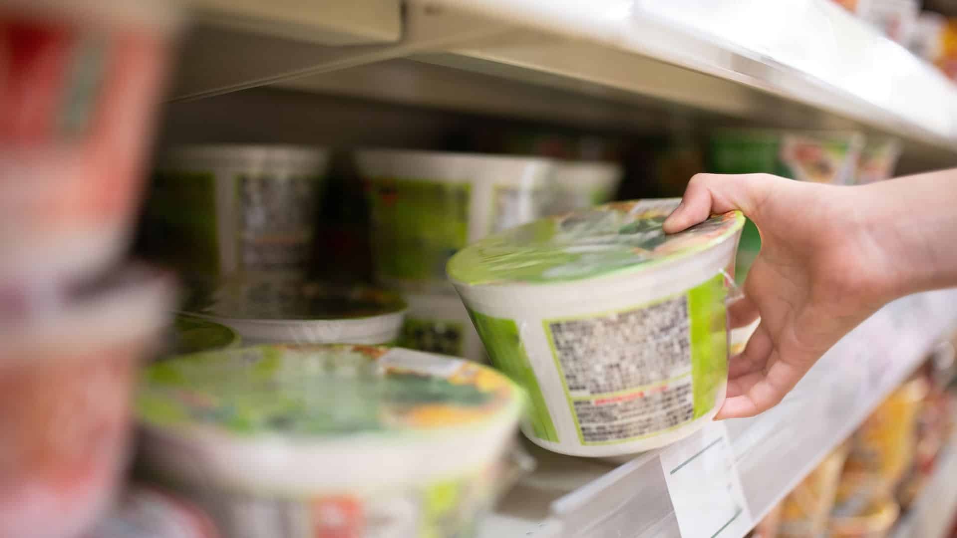 Someone buying instant ramen at a supermarket