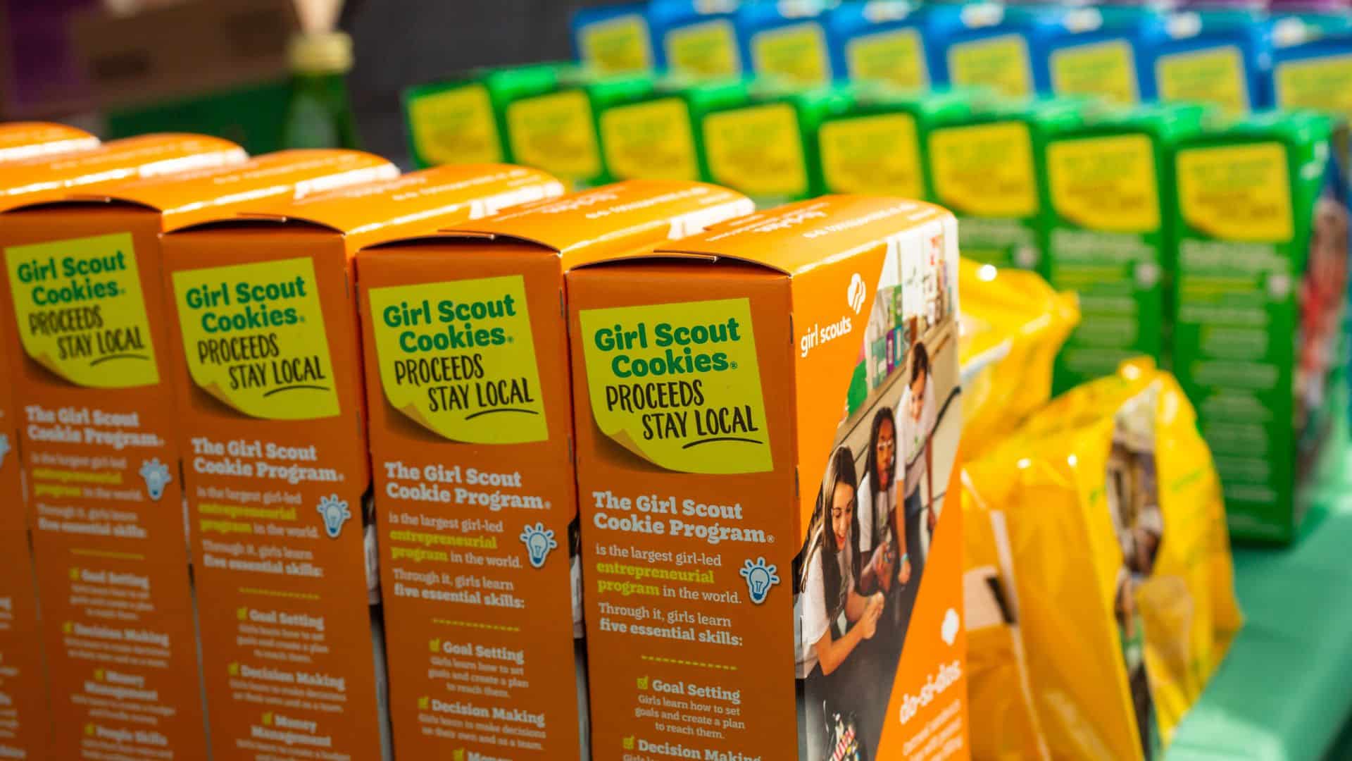 A closeup view of several varieties of Girl Scout Cookies on display on a table