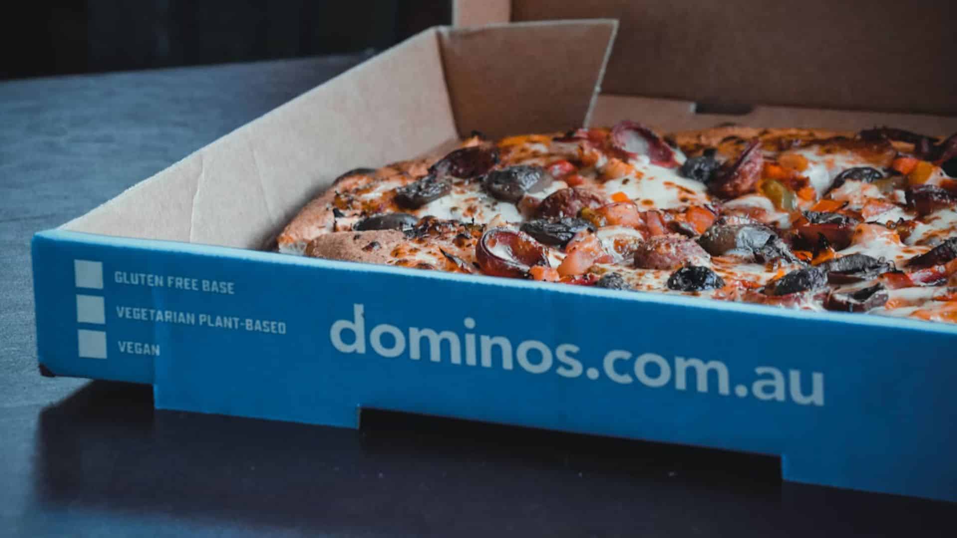 An opened box of Domino's Pizza