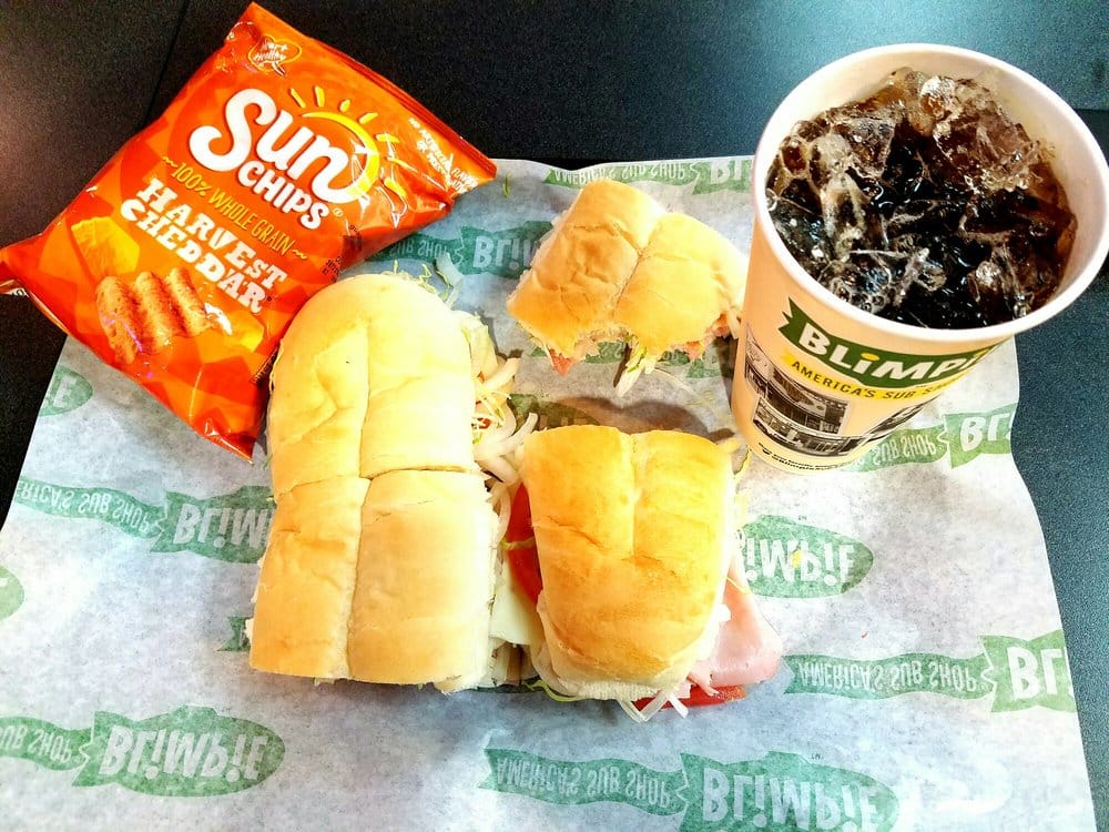 Blimpie footlong with a soda drink and Sun Chips