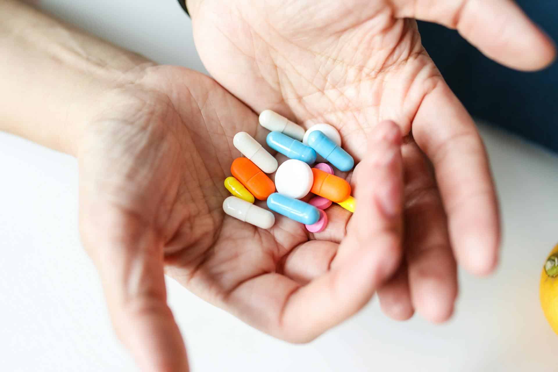Multiple pills on a person's hand