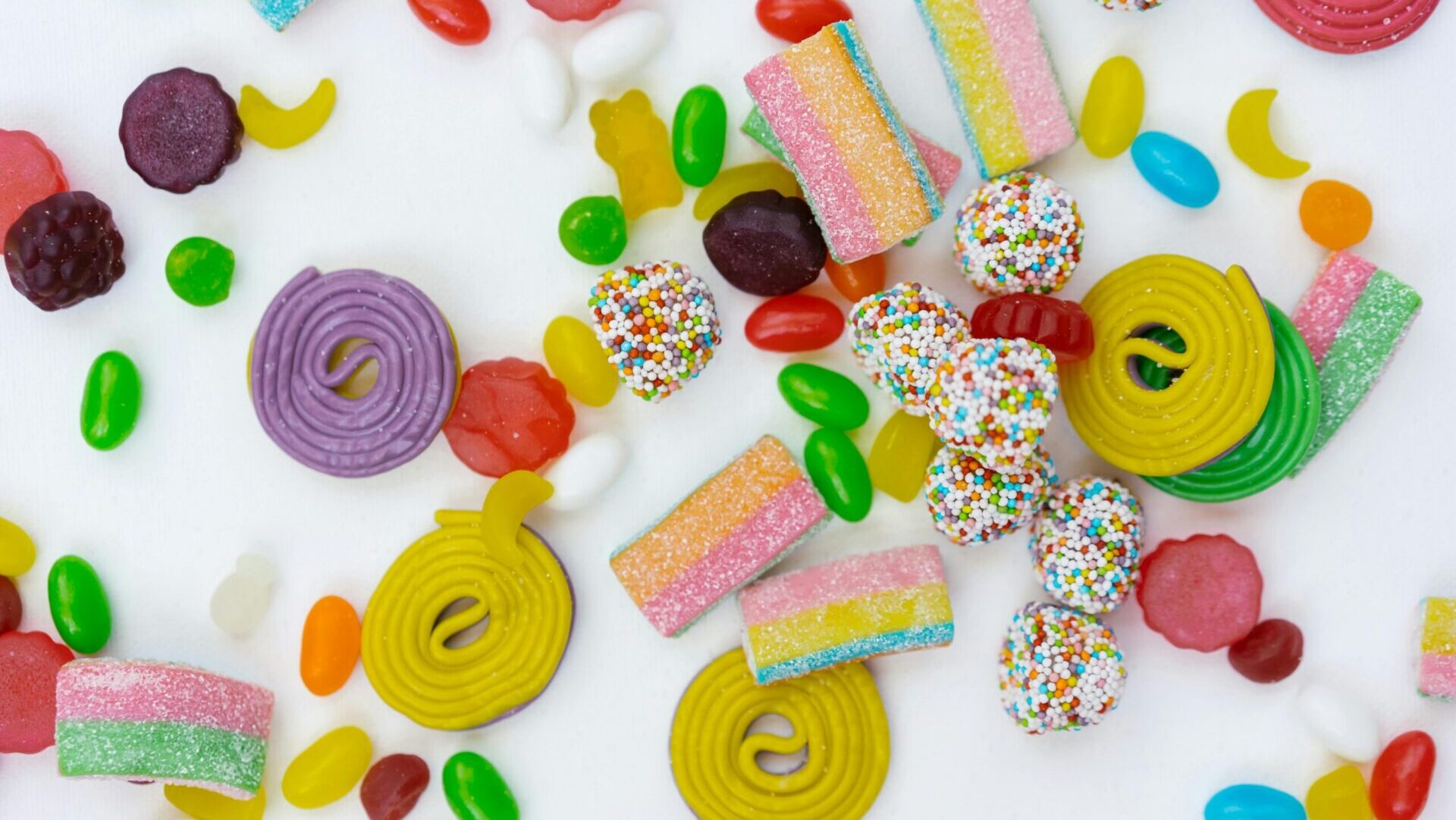 Close-up of colorful candies with sugar coating and glossy texture