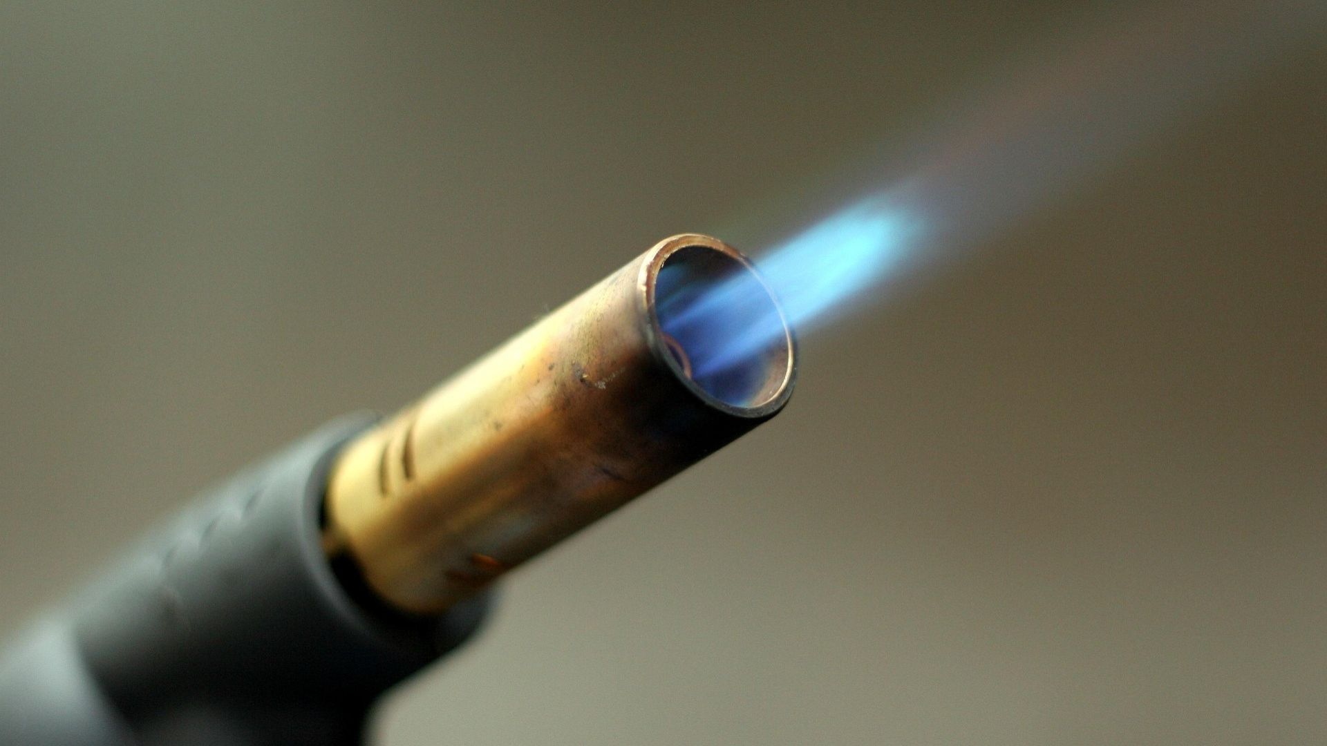 Close-up of a lit blowtorch flame used for heating or melting materials