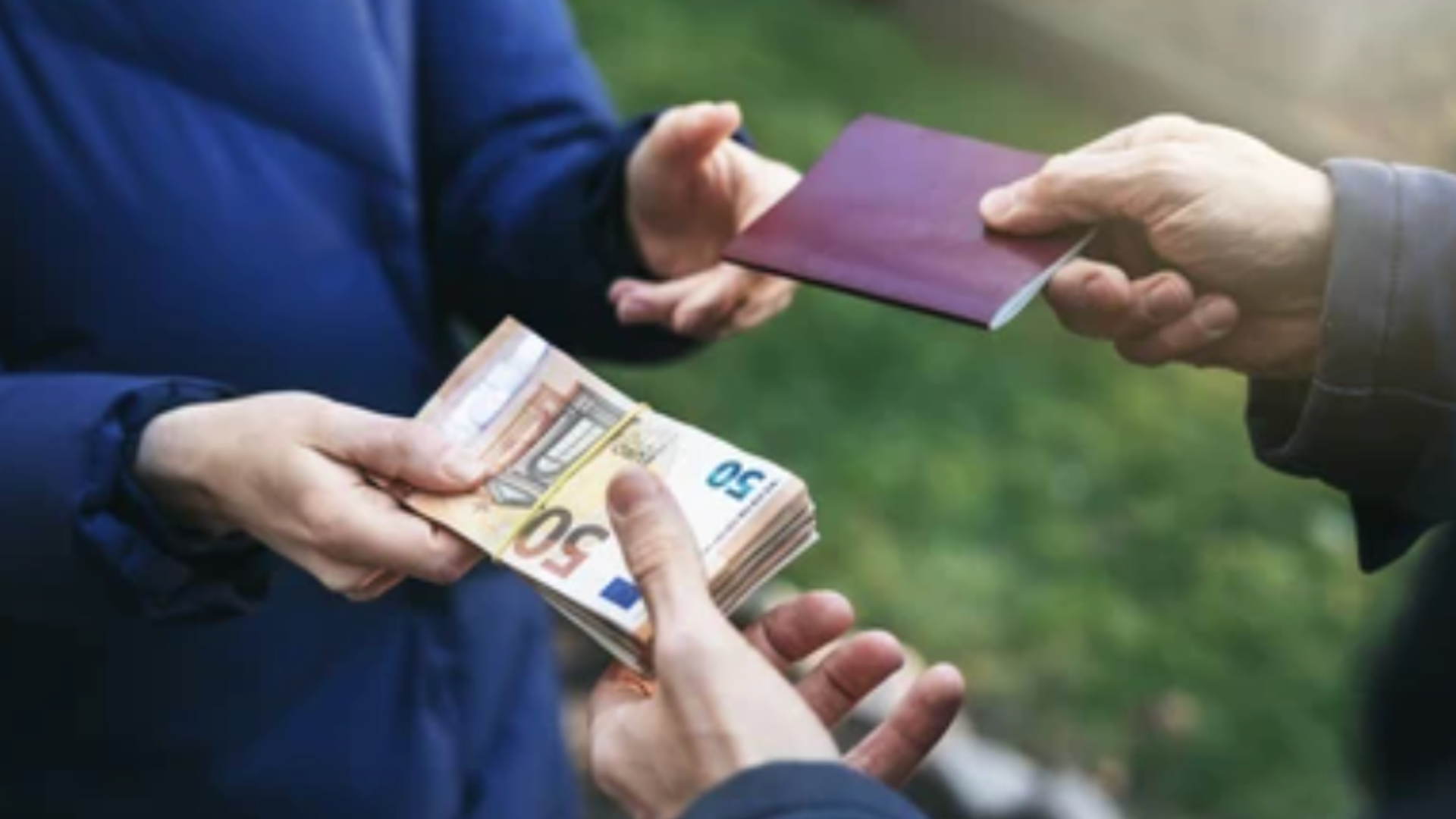 A person exchanging euro banknotes for a passport.