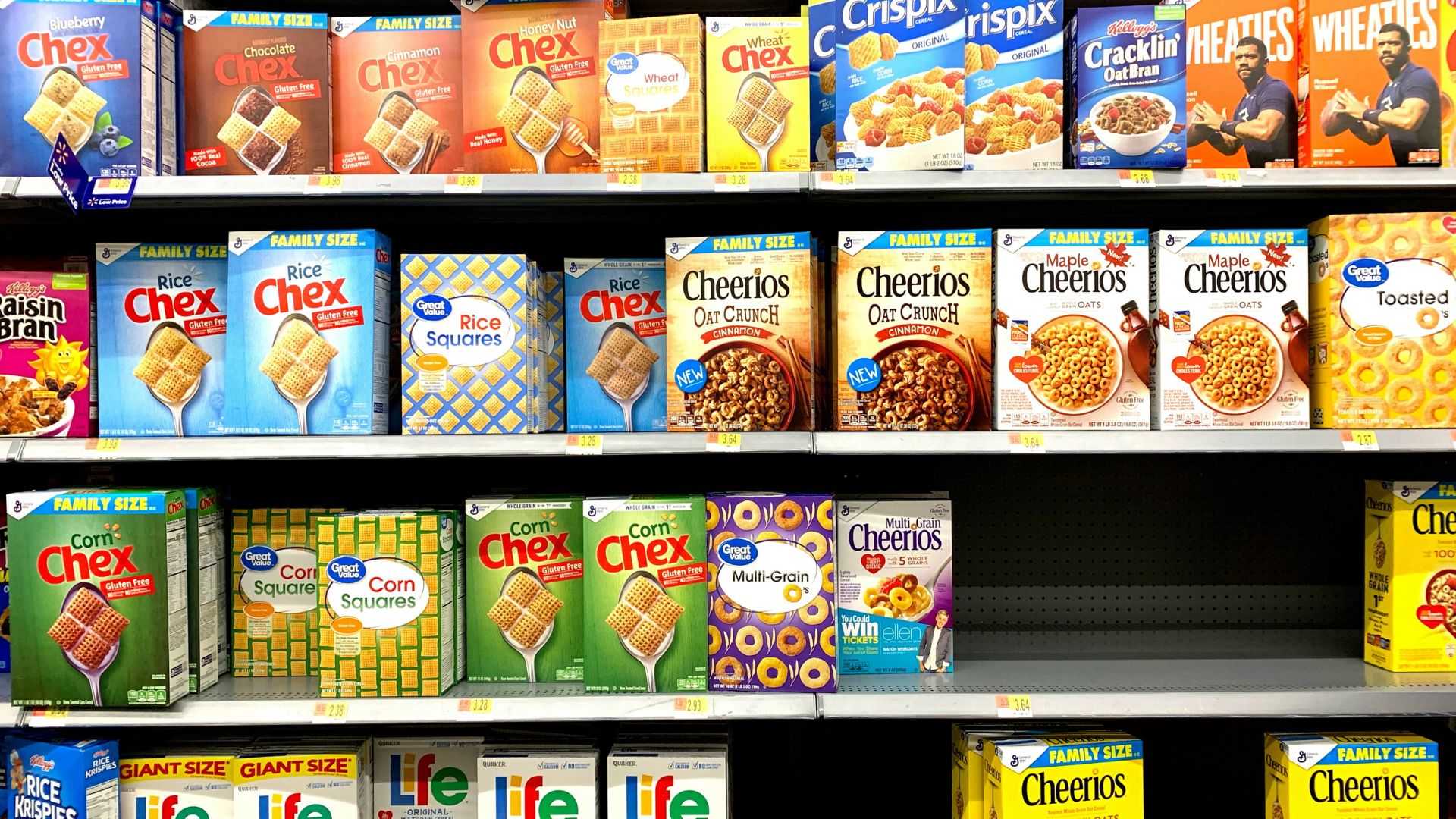 Assorted boxed breakfast cereals displayed on a store shelf.
