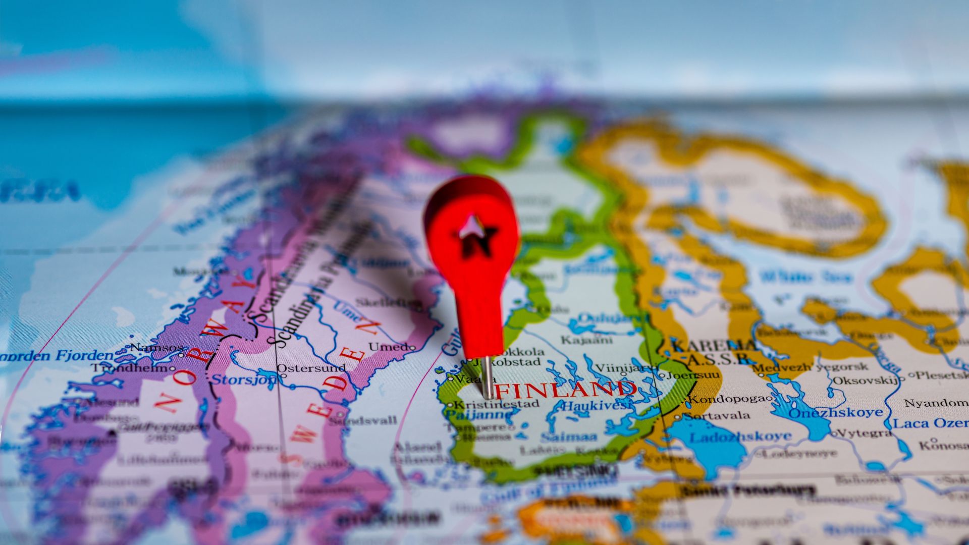 Detailed map of Finland with a red location pin placed over the country.