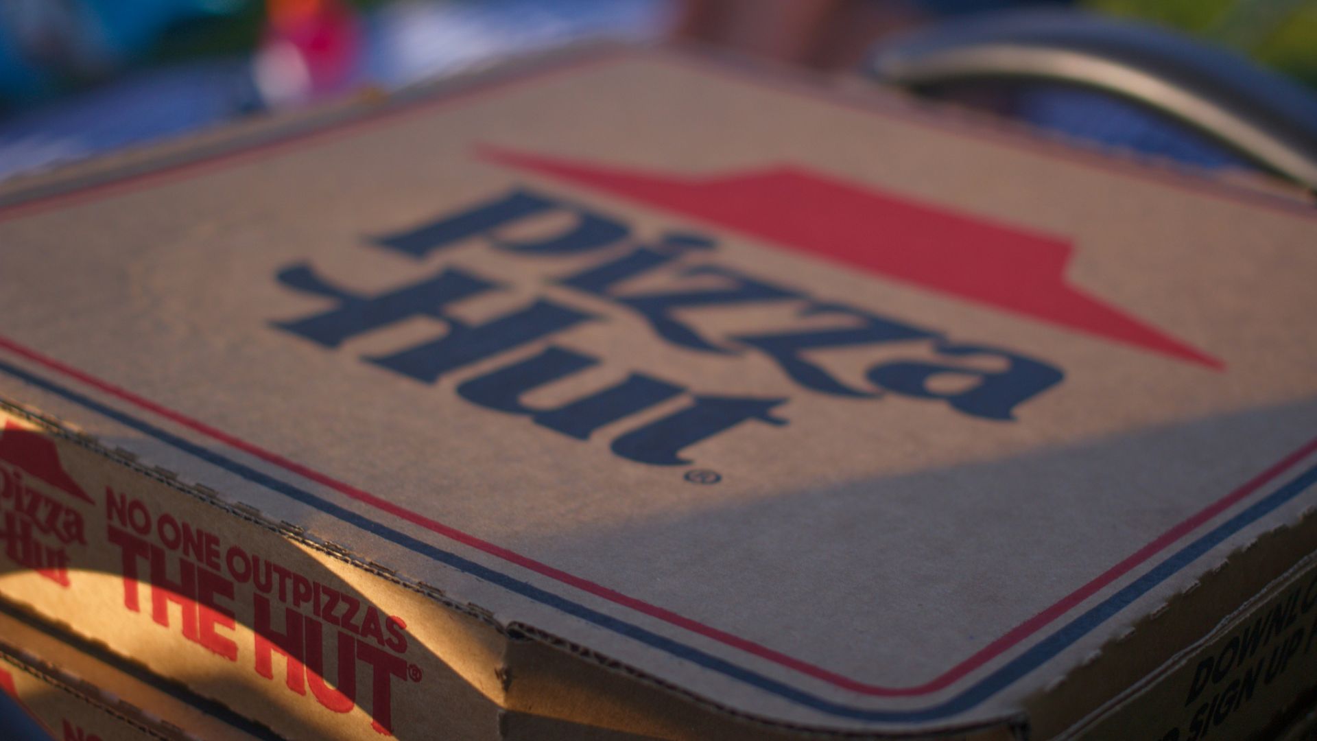 Blue and red labeled cardboard box placed on a flat surface