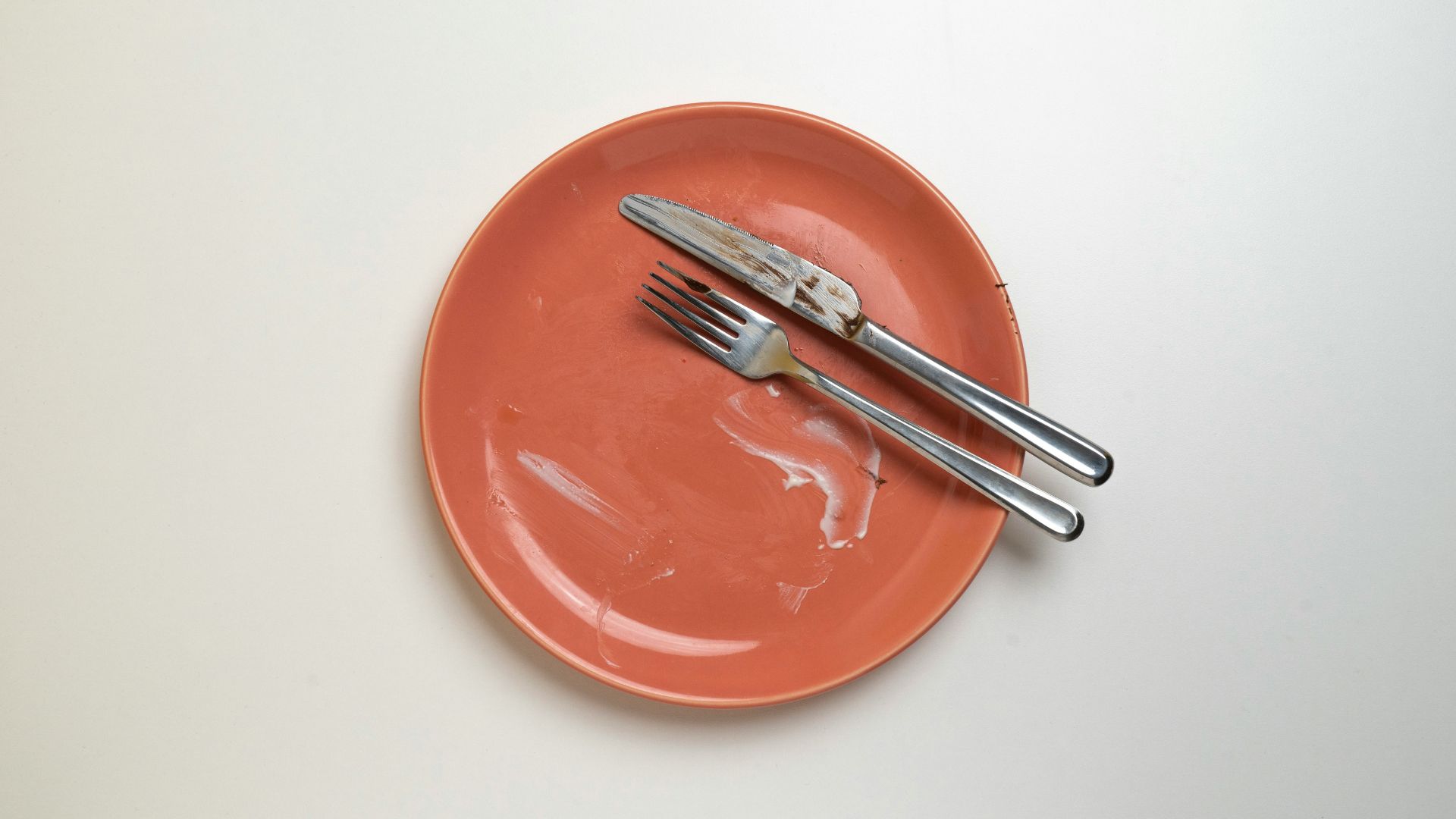 White plate with a fork and knife.