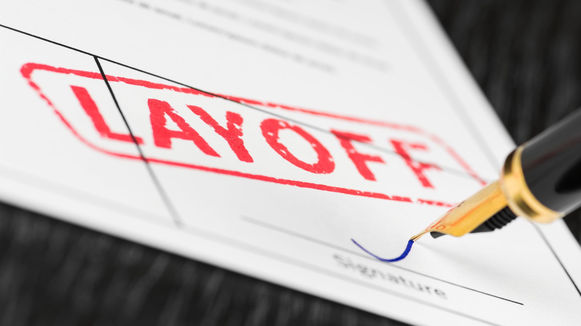 Close up of a layoff stamp on a signed official document.