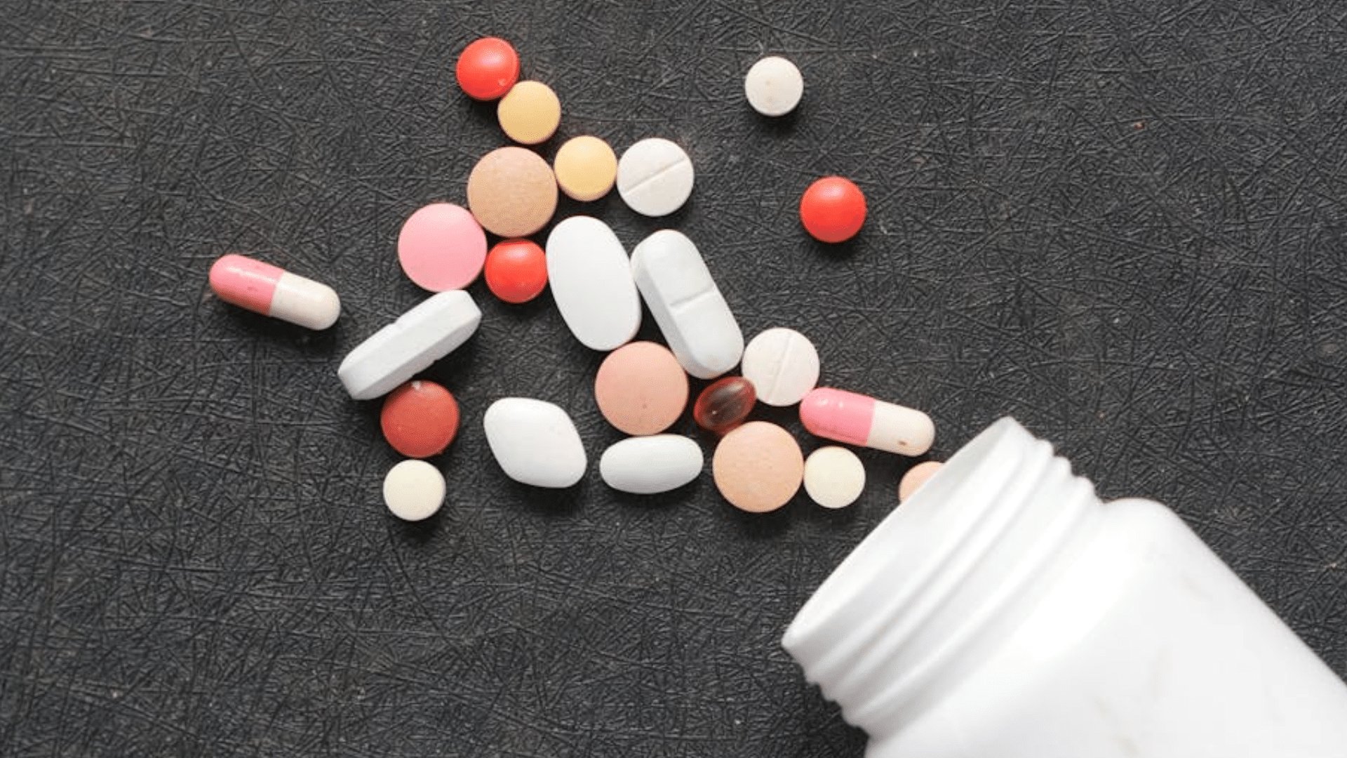 Assorted supplement in spilling bottle