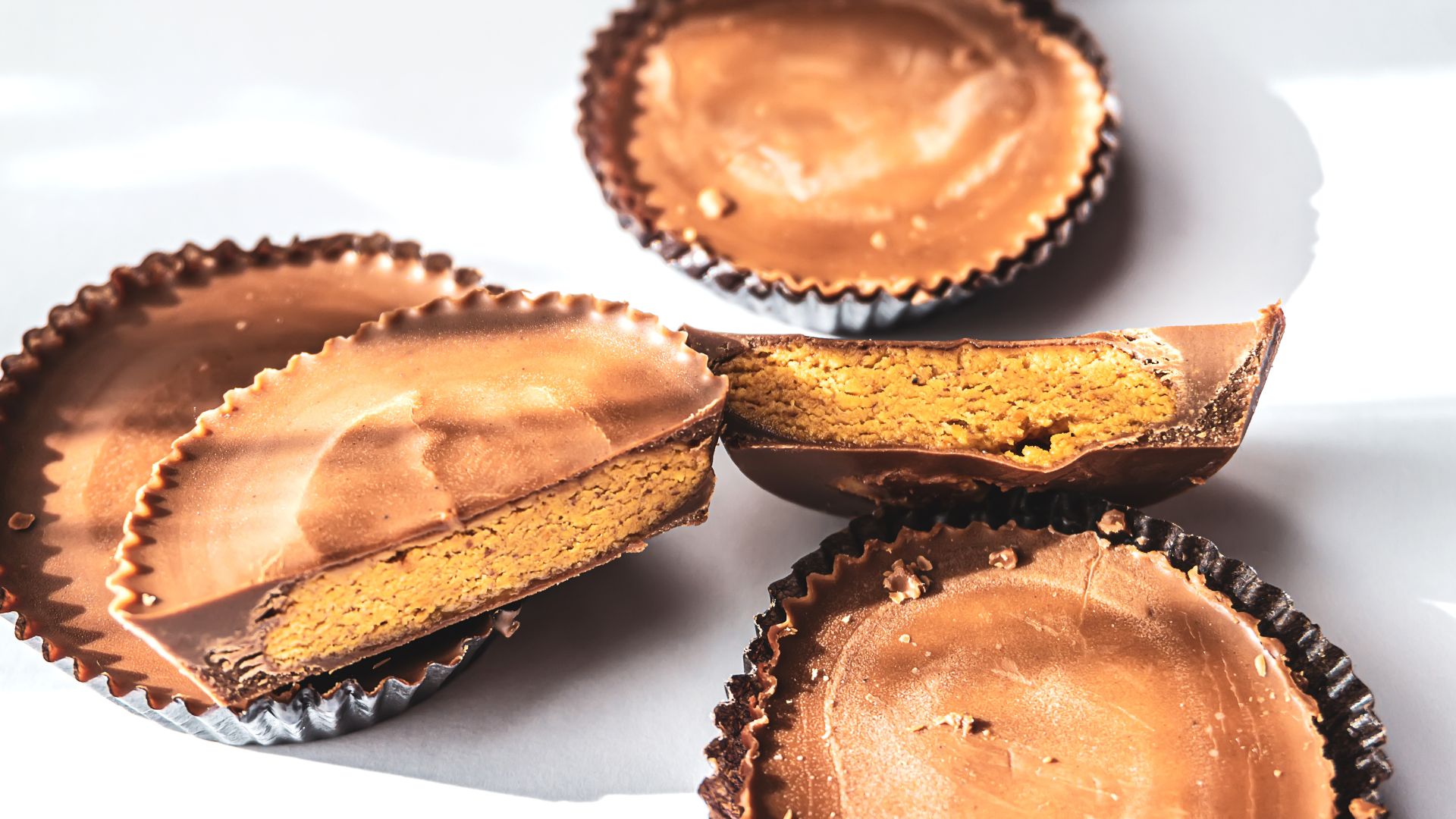Cross section of a peanut butter cup, with other cups underneath.