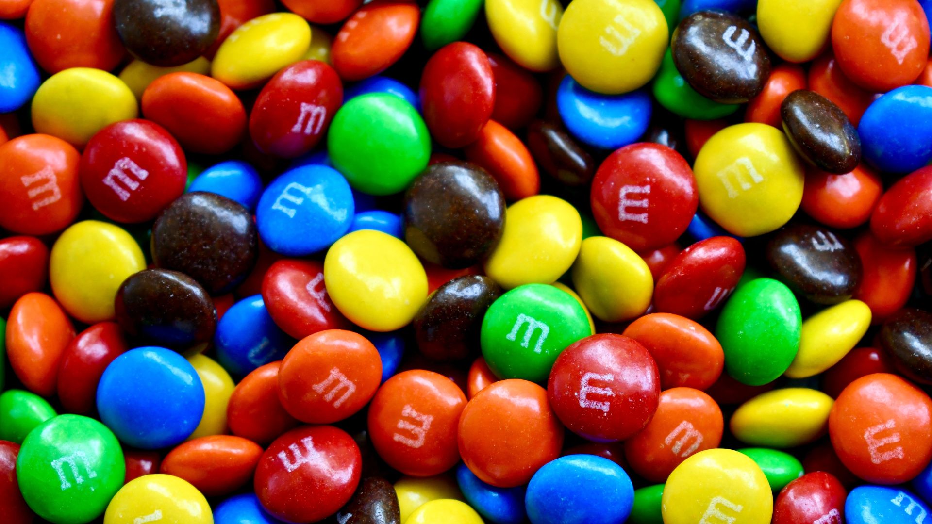 Full frame of colorful M and M’s chocolate candies, made by Mars, Inc.