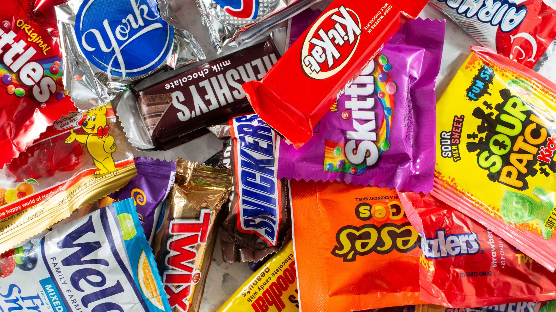 A top down view of a pile of fun size assorted candies