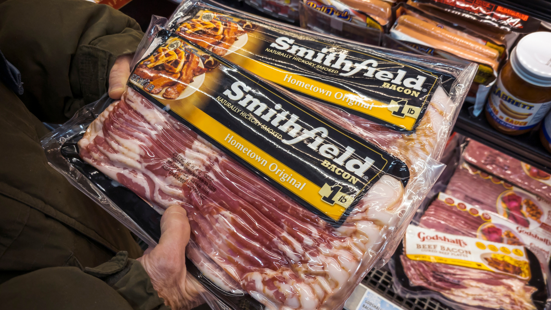 Hand Holding Smithfield Foods Bacon
