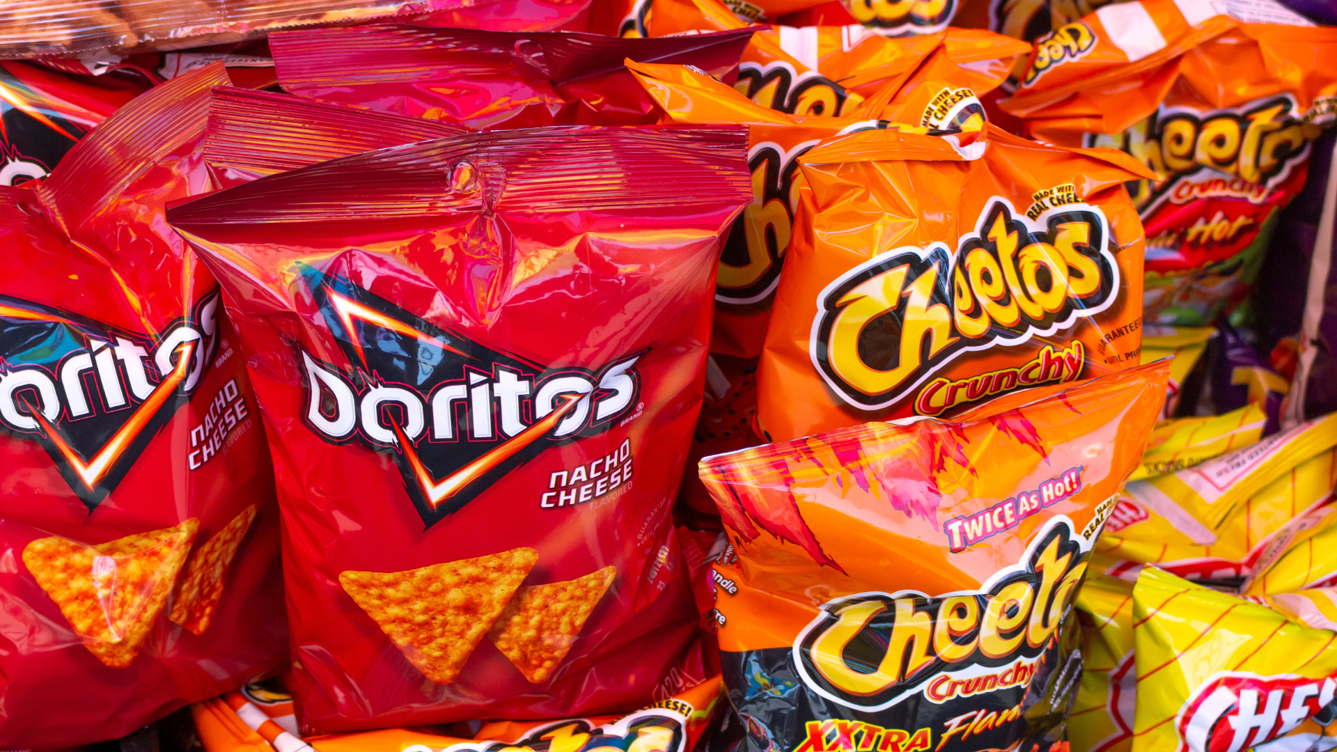 Doritos and cheetos on grocery shelf