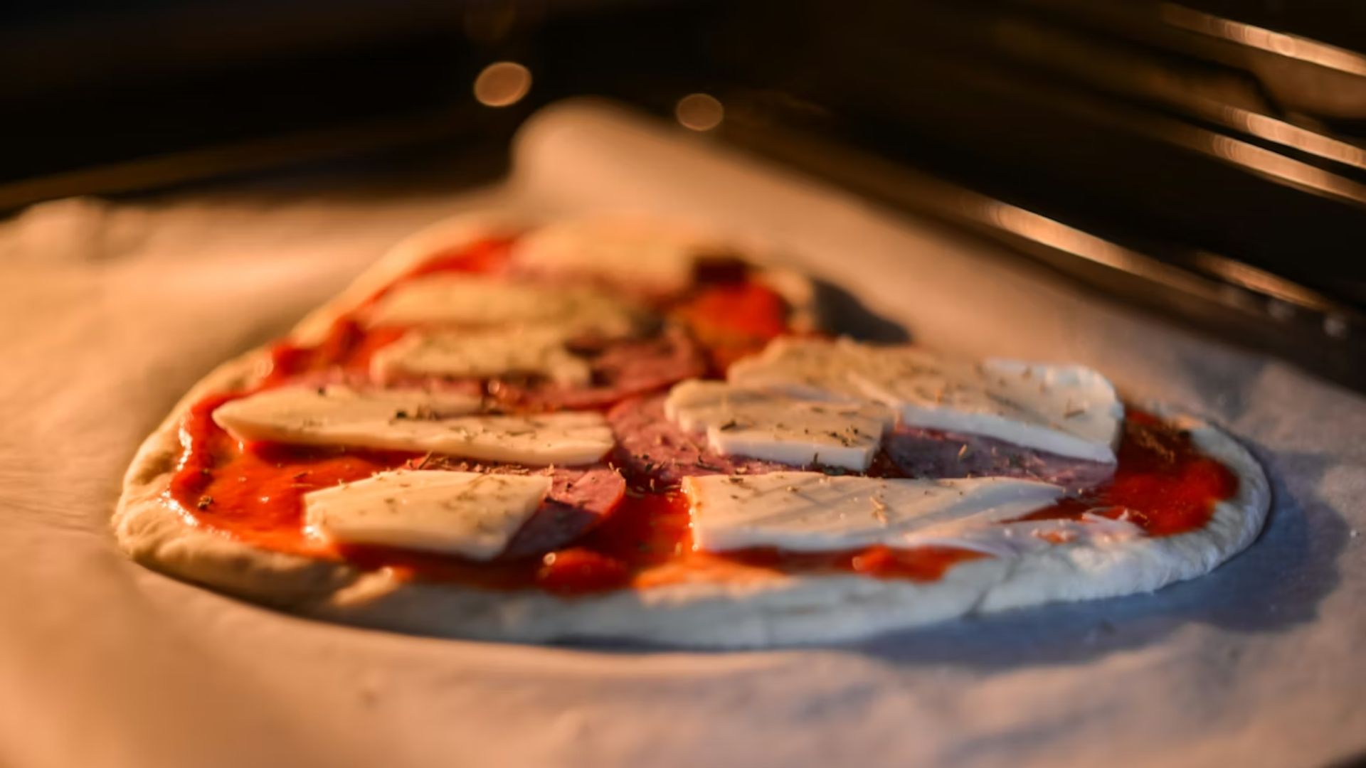 A heart-shaped pizza cooking in an oven