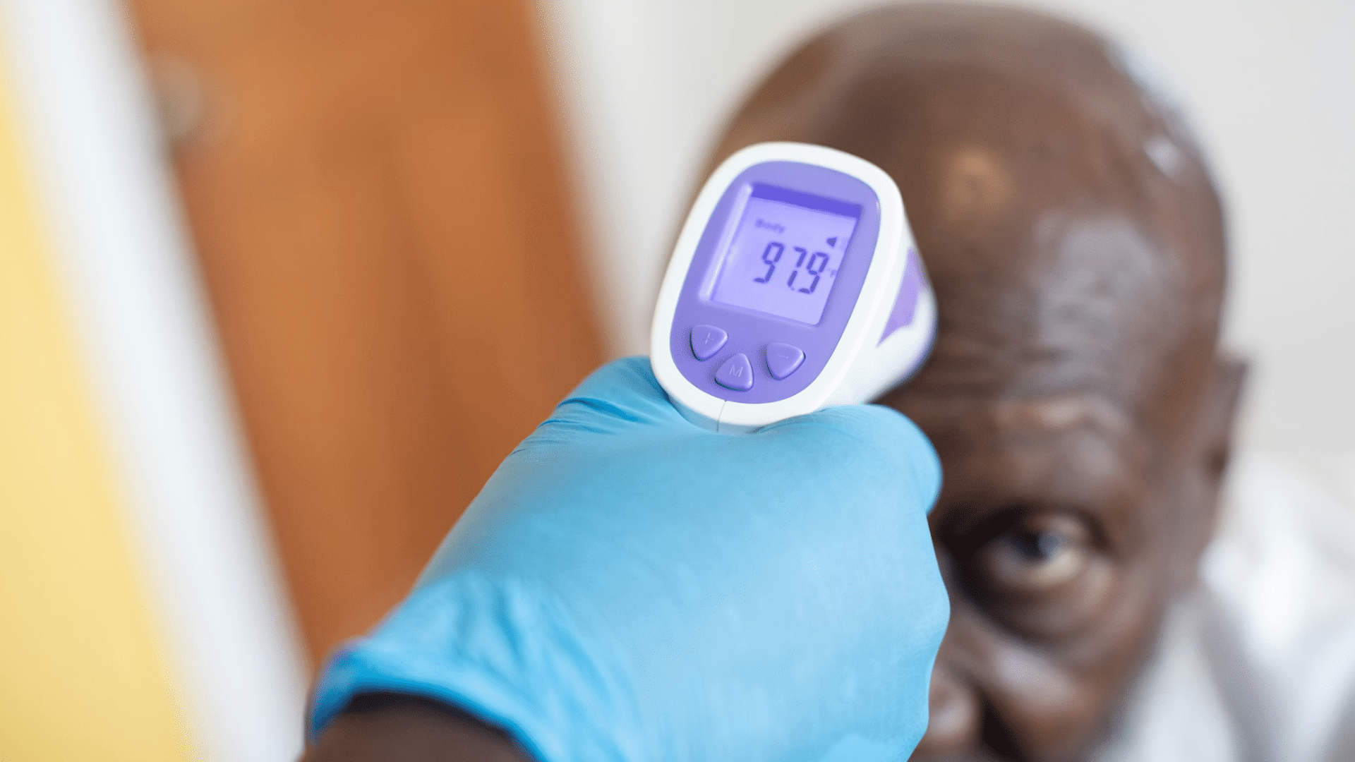 man getting his temperature checked