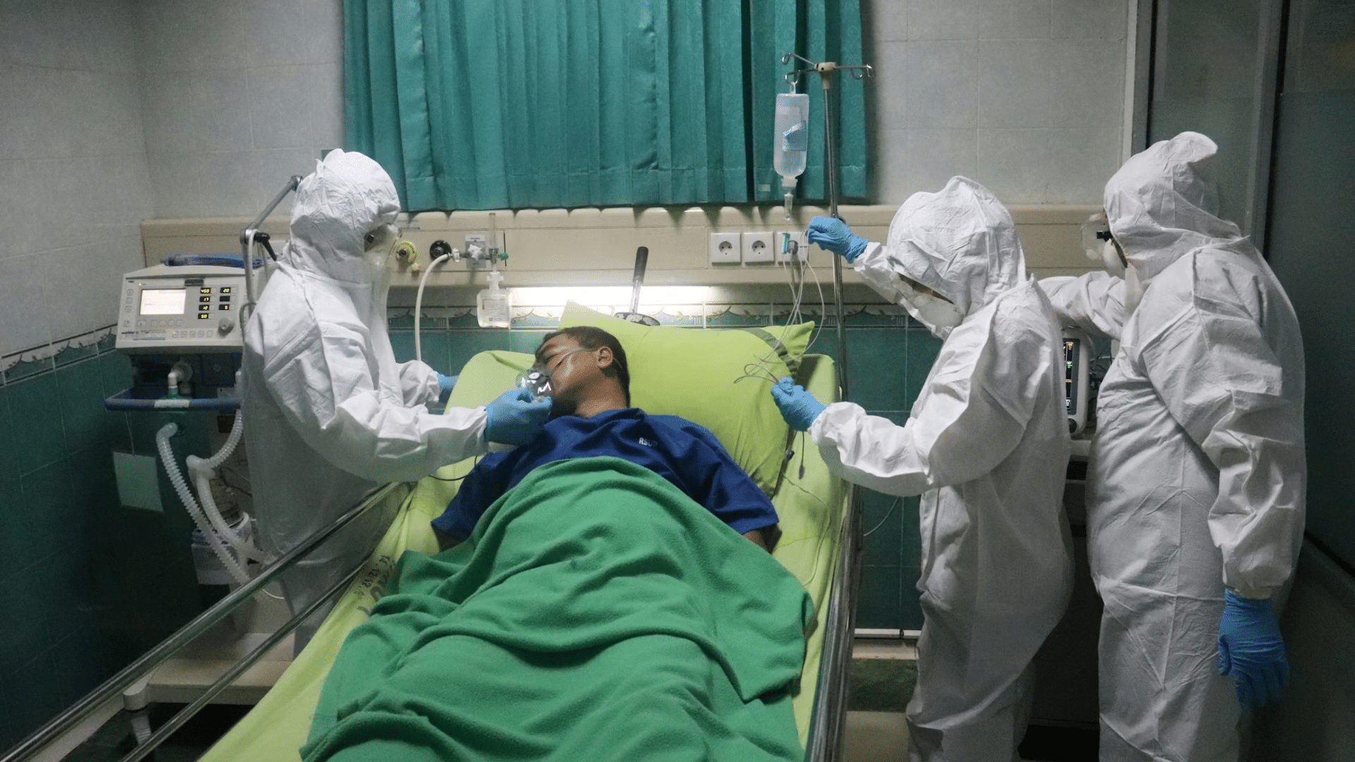people wearing full PPE treating patient
