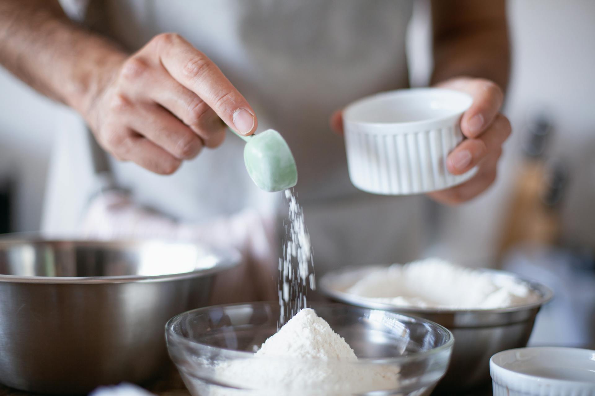 Man pouring cake mix powder on a bowl
