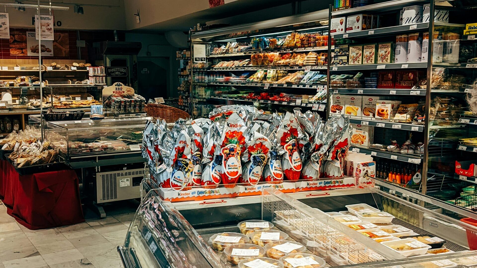 Assortment of packaged foods including canned goods, frozen meals, and boxed products arranged together.